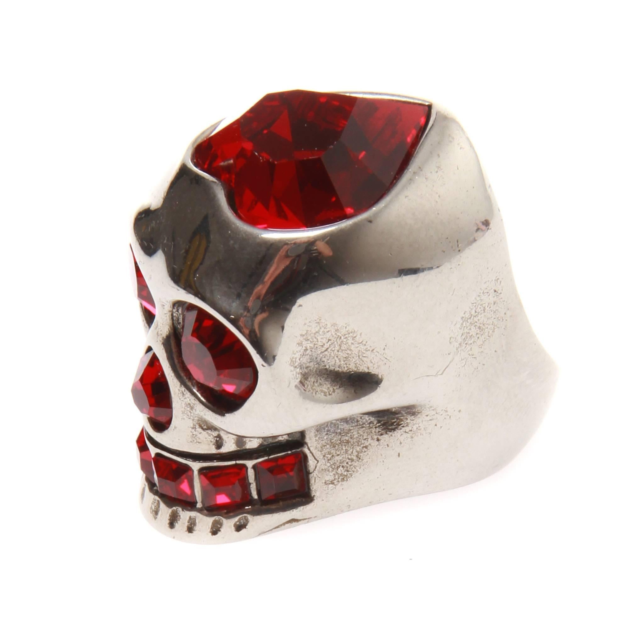 Alexander McQueen skull ring in silver-tone metal embellished with ruby red Swarovski crystals. Features a love heart cut crystal at top. 

Comes with jewellery pouch. US 6.