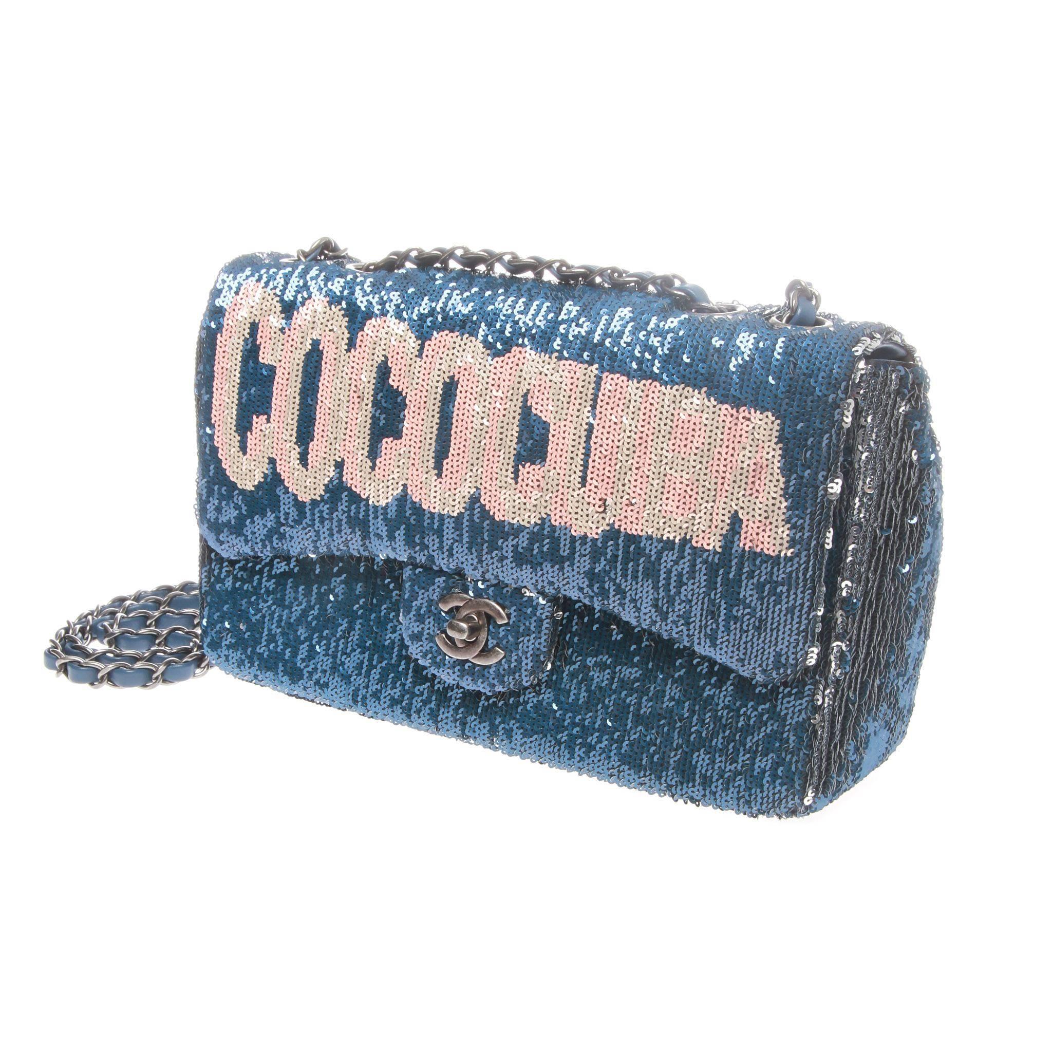 Rare and incredibly sought after Chanel bag from the Cruise 2017 collection. Rendered in dynamic blue and gunmetal two-tone sequins with a feature 'COCOCUBA' graphic on the front flap inspired by the city lights of Havana. 

Medium flap bag features