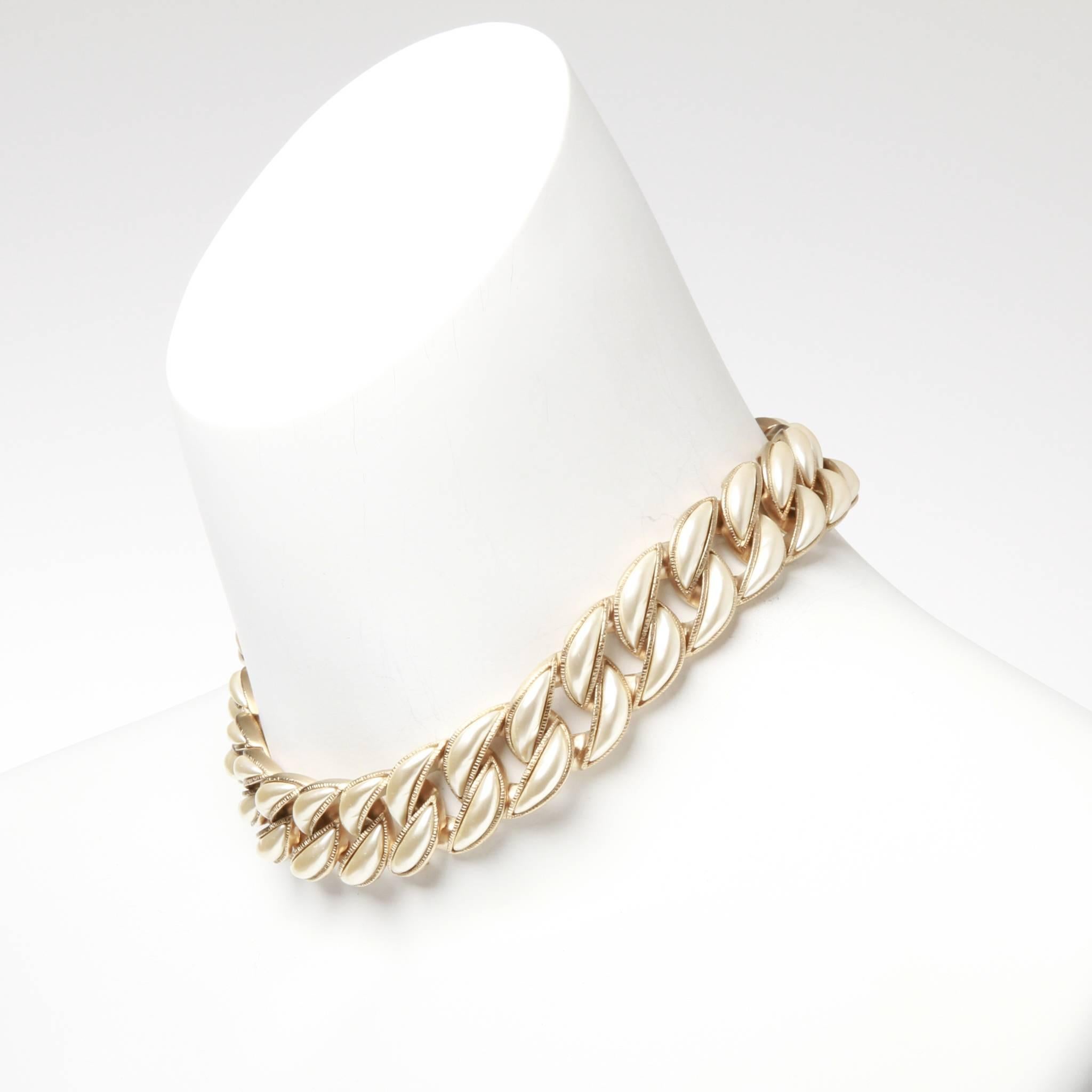 Pale champagne gold-tone Chanel curb chain choker featuring pearl embellishment and adjustable lobster clasp closure with CC charm. Stamped A15 B. 

With authentic and original box and jewellery pouch.


