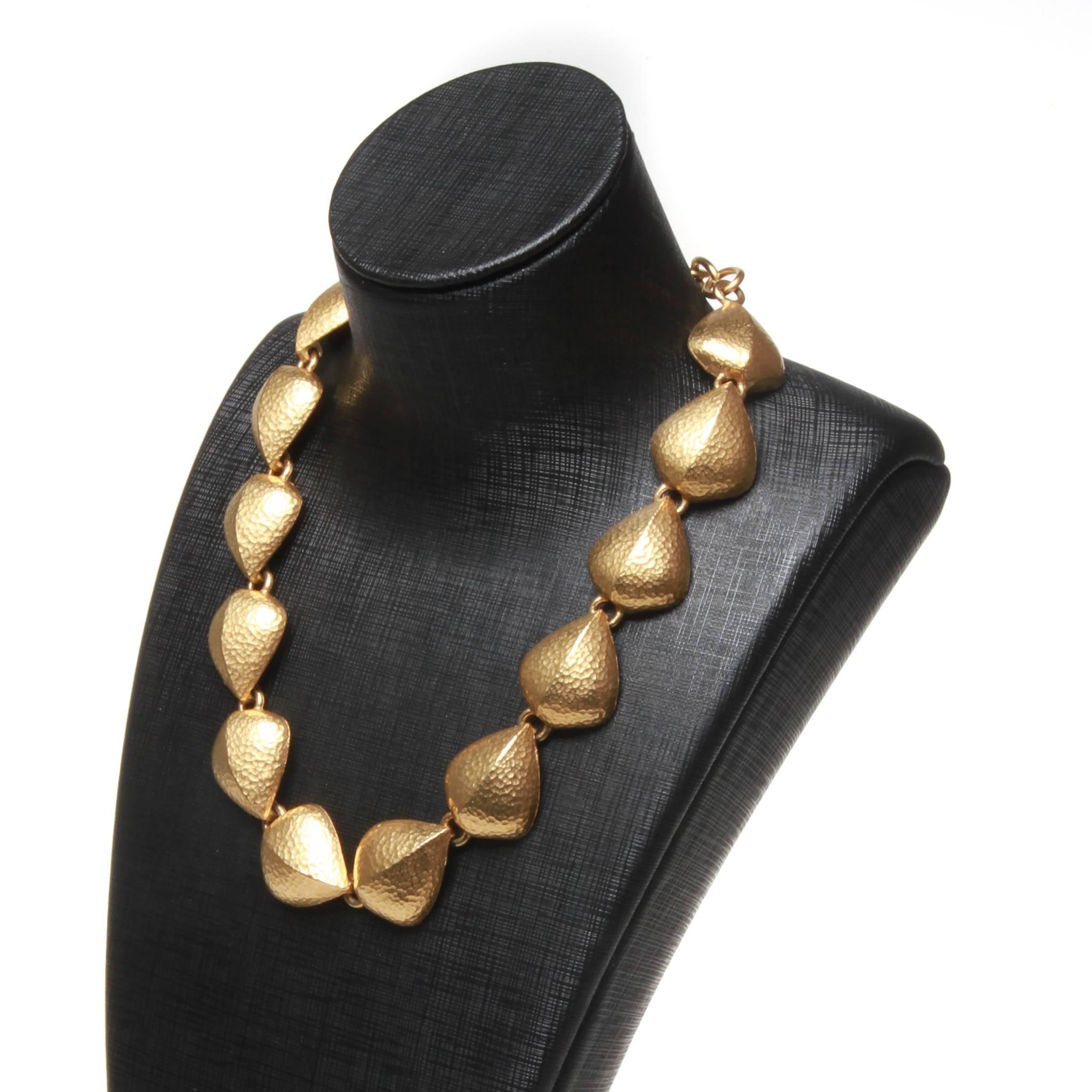 Vintage Givenchy necklace featuring a string of matte gold-tone, hammered metal links with hook closure at the back. Length of chain at back for adjustability. 

40-52cm adjustability