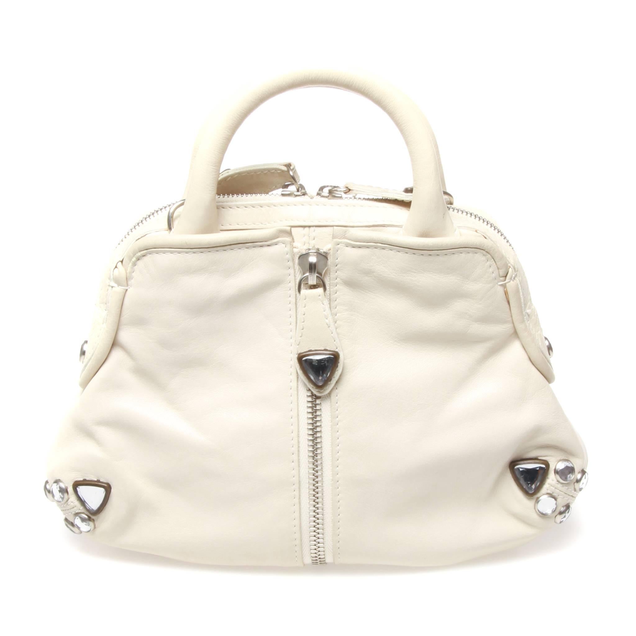 Sonia Rykiel handbag in white leather featuring silver hardware and zip flap opening design feature. Comes with strap. 

