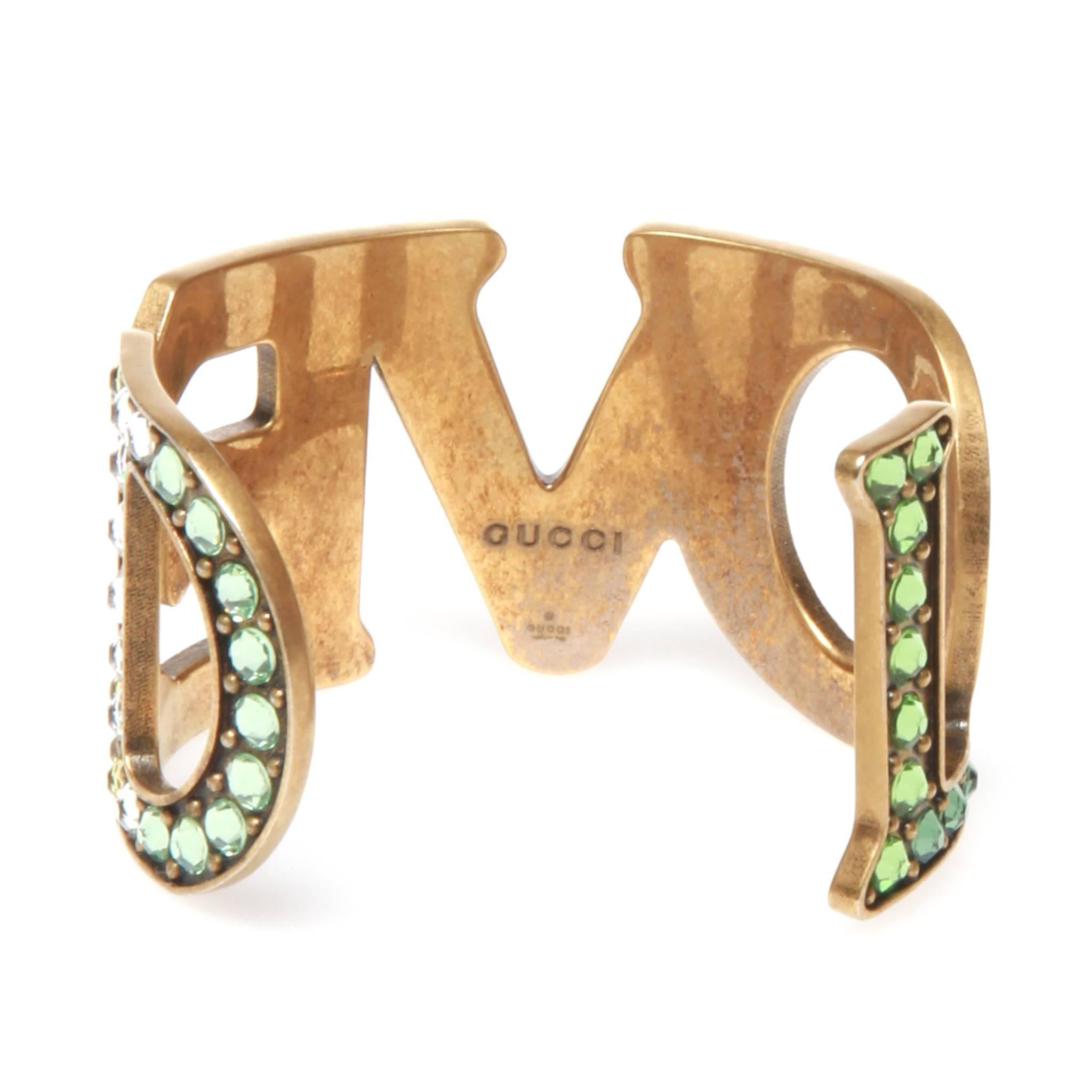 Gold-tone Gucci Loved cuff featuring multicolor crystal. Includes jewelry pouch and box.

6cm diameter at widest part. Open cuff. 