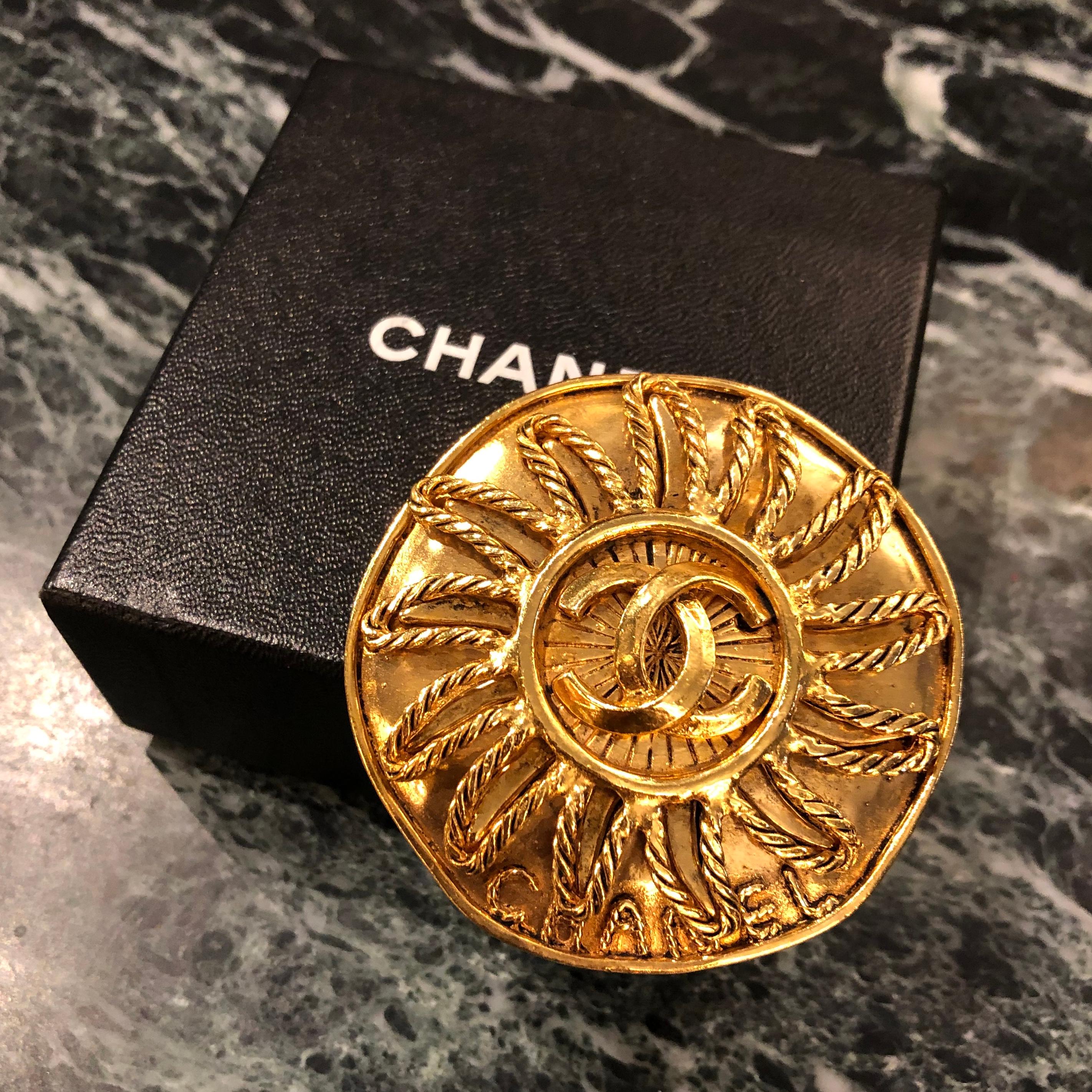Contemporary Chanel gold sun brooch with double CC