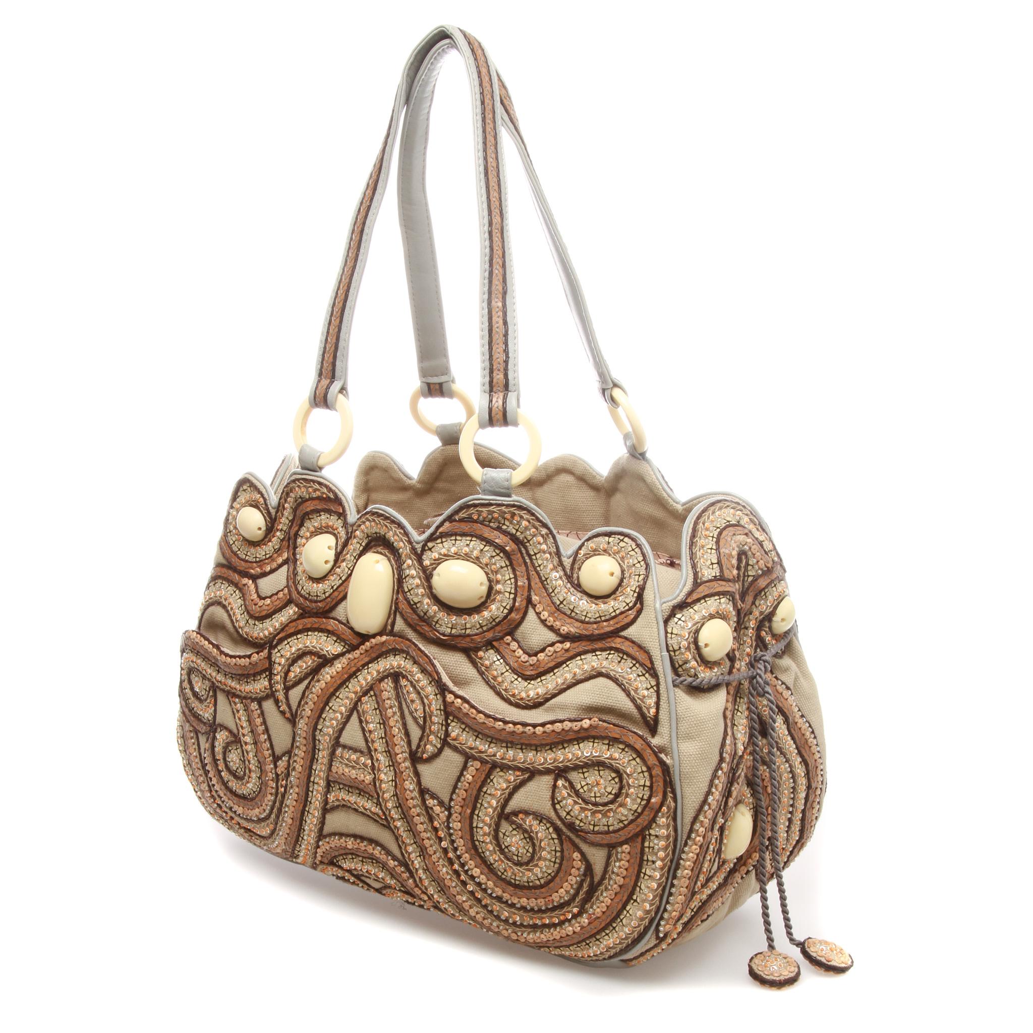 A unique Handmade Jamin Puech Sequin Patterned Fabric Top Handle Handbag 

Beautifully crafted Austrian crystal beads embellished unique shape handbag.
It features a central flap closure and a double straps handle.