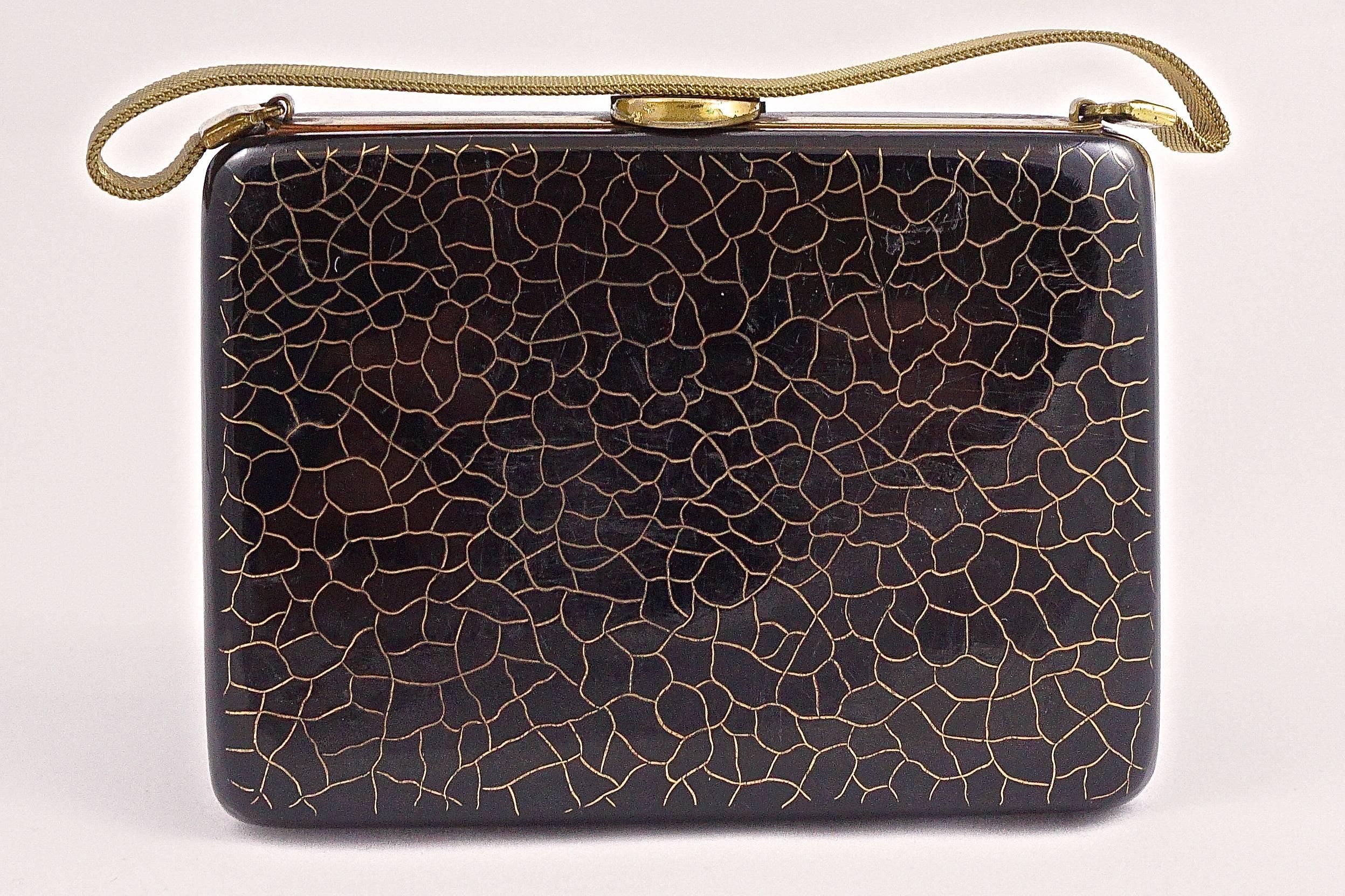 This is a L. S. Mayer 'Burlington' black art deco carryall compact purse with a gold tone crackle design to the front and back, and a mesh handle. Measuring 9.5cm (3.7 inches) width, by 6.8cm (2.68 inches) height, and maximum depth 5.2cm (2.08