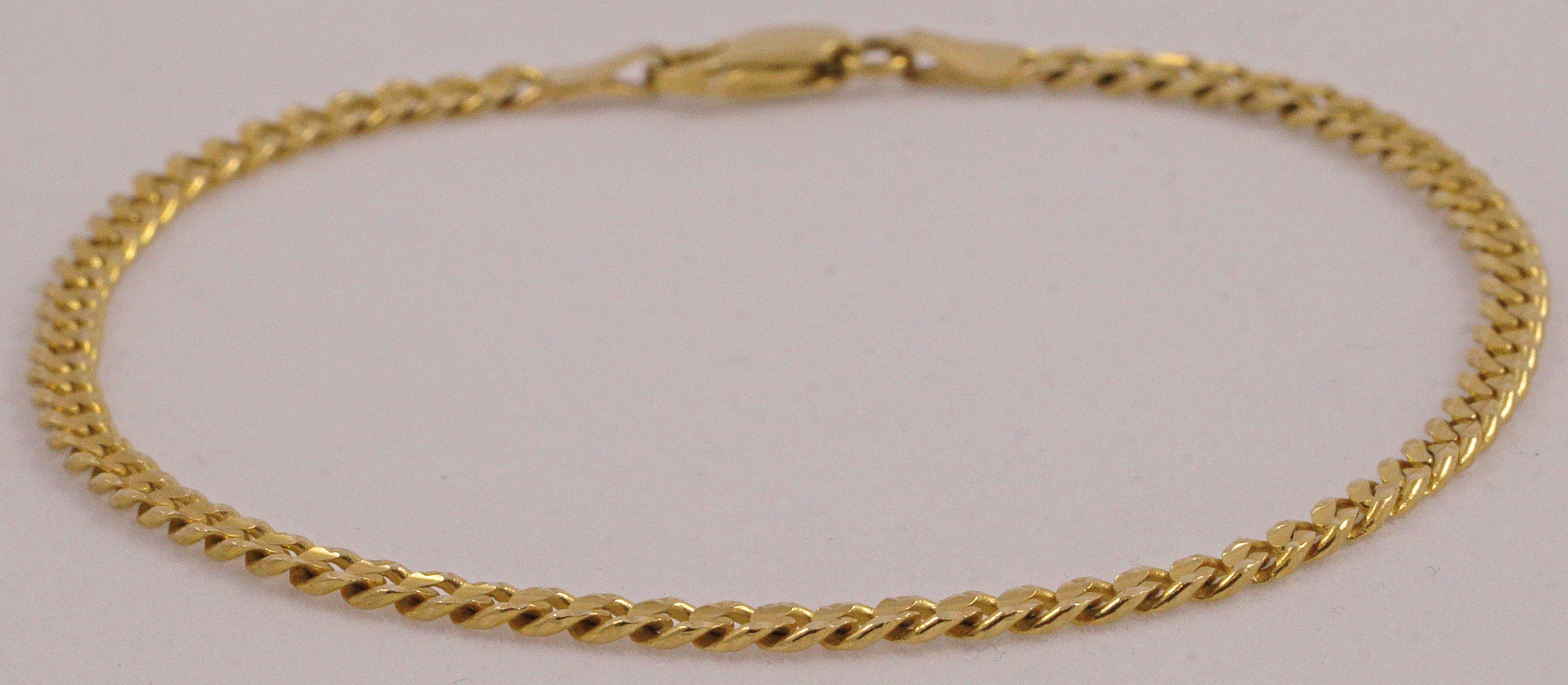 

14K gold bracelet, featuring a fancy cut link design. The bracelet is stamped ah, Italy, 985, 14K, and measures length 19cm (7.5inches) by width 3mm (.12 inch).

This is a beautiful yellow gold Italian bracelet with unusual links, in very good