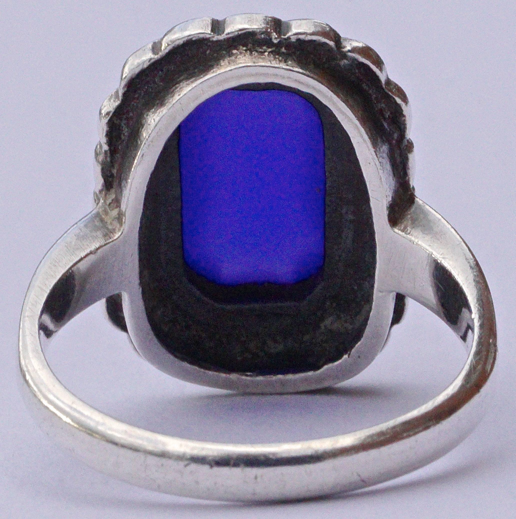 Art deco silver ring with a row of marcasites surrounding a beautiful blue chalcedony. Ring size UK K, US 5 1/4. The front measures 1.7cm, .7 inches x 1.3cm, .5 inches and the setting is depth 6mm, .2 inch. The inside band is stamped SILVER.

This