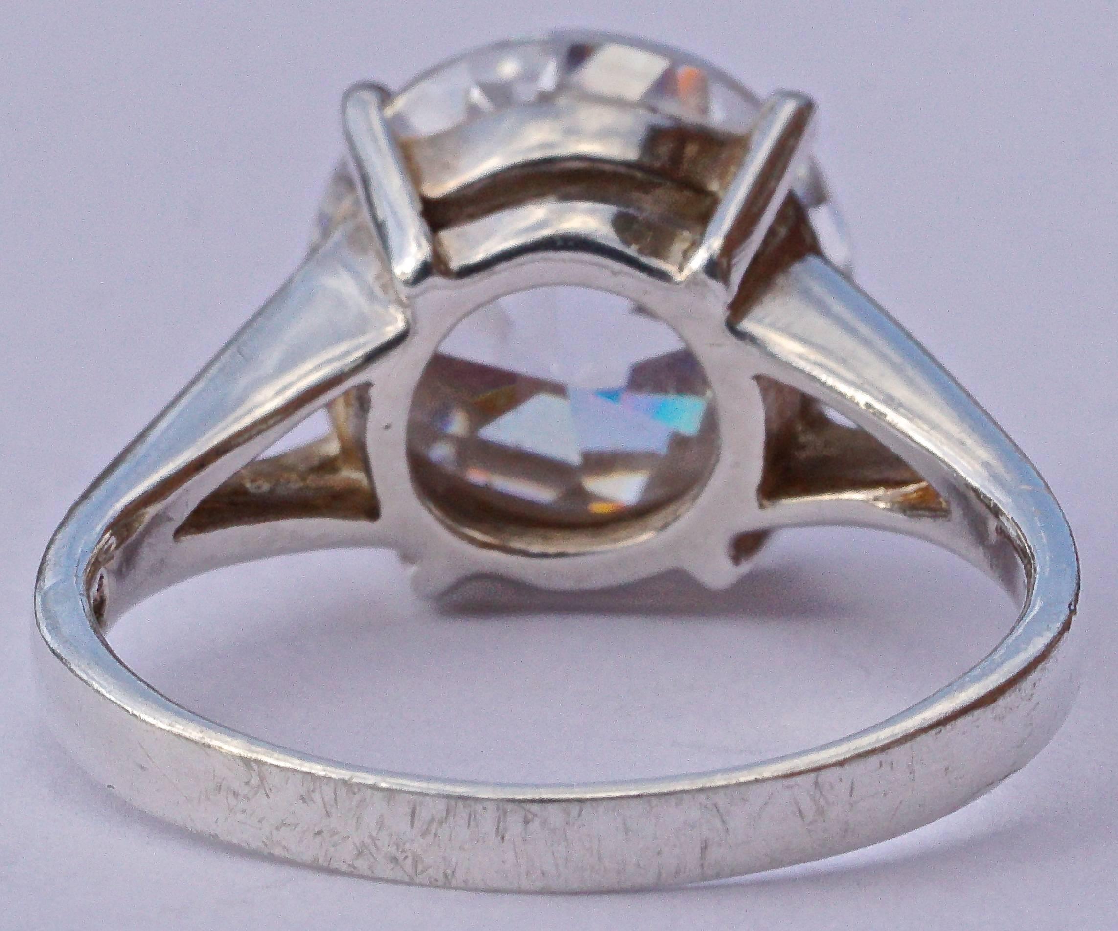 Silver and faceted clear stone solitaire ring, size UK Q 1/2, US 8 1/4. The large solitaire jewel is 1.2cm, 1/2 inch diameter, and the setting is 5mm, 1/5 inch depth. The inside band is stamped 925.

This is a fabulous sparkling vintage ring, for
