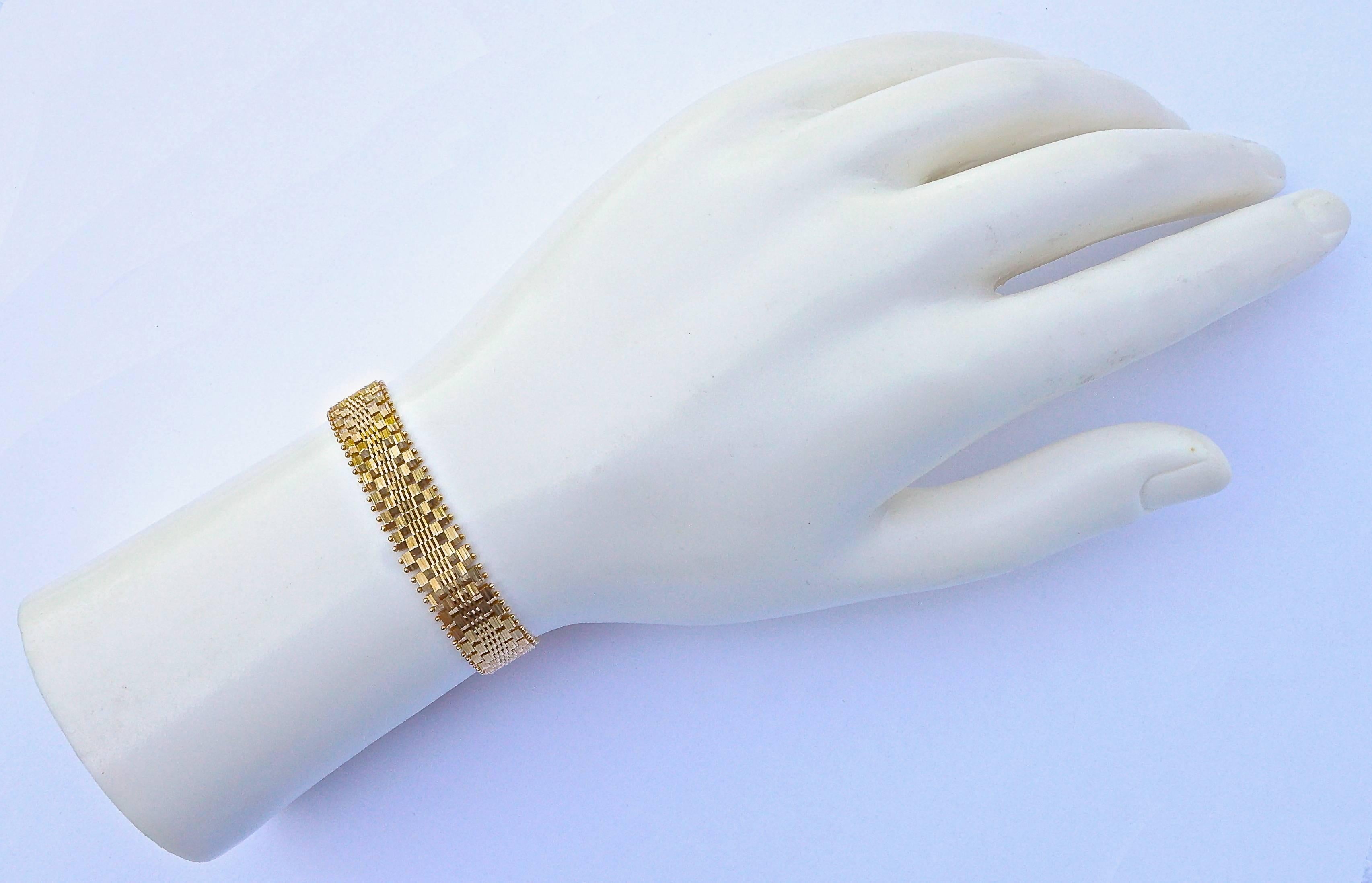Fine 14K gold bracelet by Imperial Gold, with a safety hook. It has a beautiful mirrored link design edged with gold balls. The front is textured and the back is flat. Measuring length 18.5cm / 7.29 inches by width 1cm / .39 inch. The clasp is