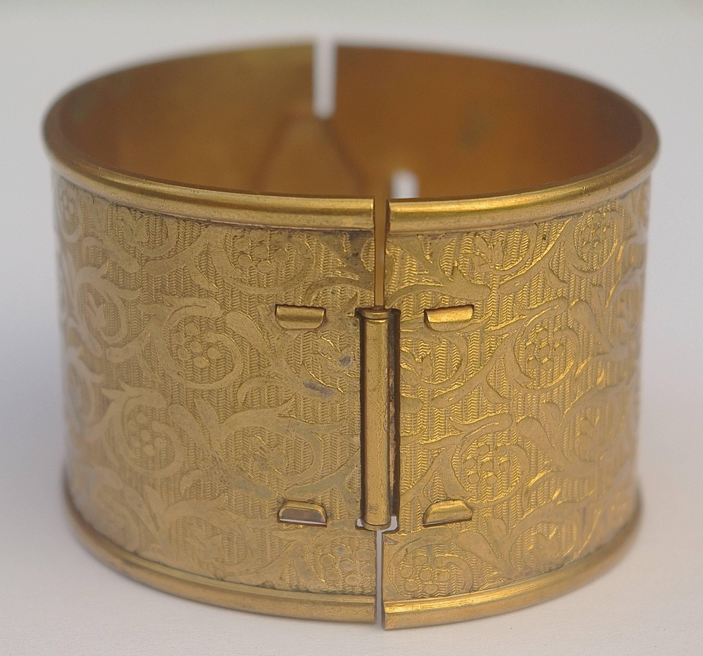 Original early twentieth century oval shape wide gold tone bangle bracelet, featuring a wonderful floral design. Width 3.5cm / 1.38 inches, and inner circumference 17.5cm / 6.89 inches. There are signs of age to the inside band, the outside is in