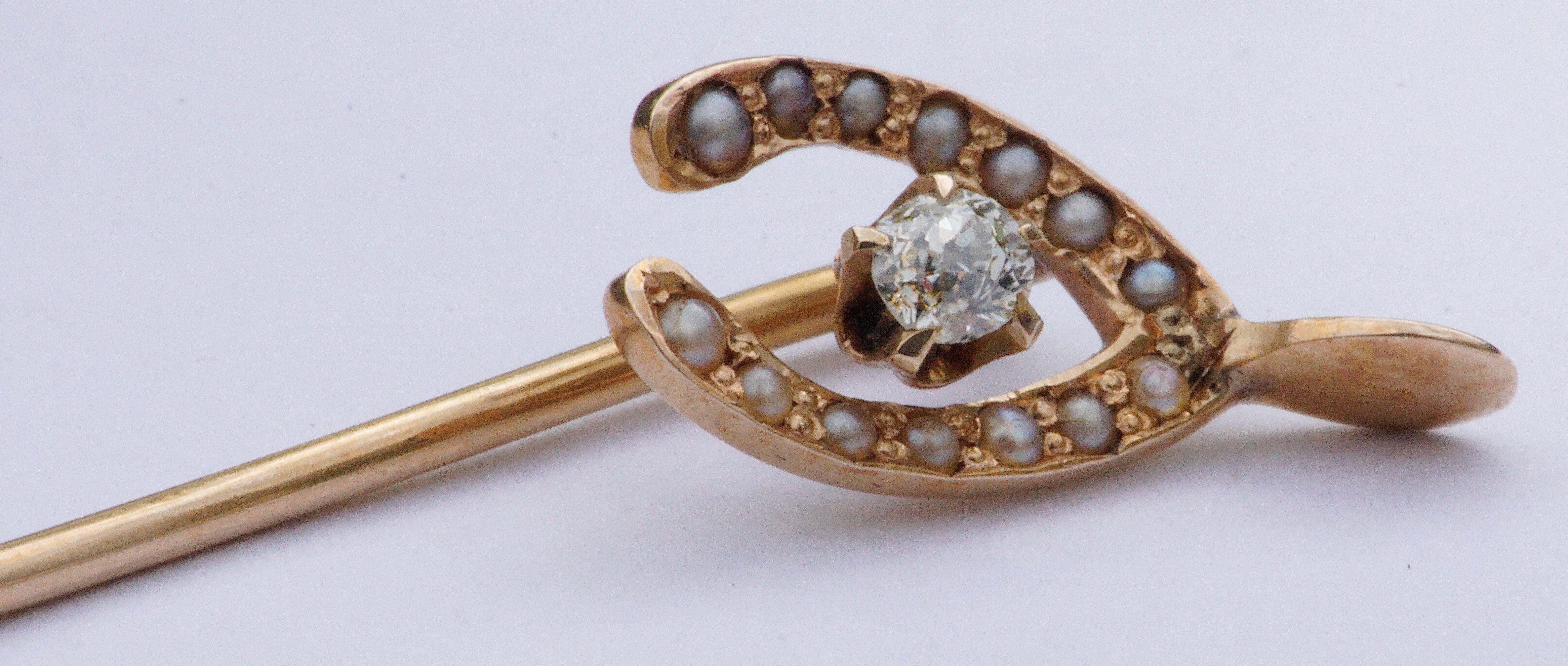 Antique Victorian to Edwardian 14K gold stick pin in a wishbone design, set with a .04 carat diamond and fourteen seed pearls. Stamped 14K.

Length 5.8cm, 2.28 inches, and weight 1.1g.  The wishbone is 7mm, .27 inch by 1.4cm, .55 inch. This is a
