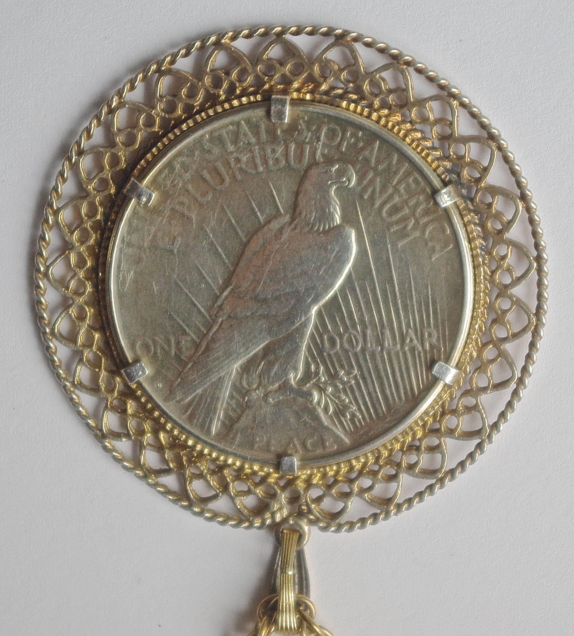 Vintage gold filled one dollar liberty peace coin, set in an intricately detailed surround, the chain is stamped 1/20 12K GF.
The lovely pendant is diameter 5.3cm, 2.08 inches, and the fancy chain is length 62cm, 24.41 inches.

This is a beautiful