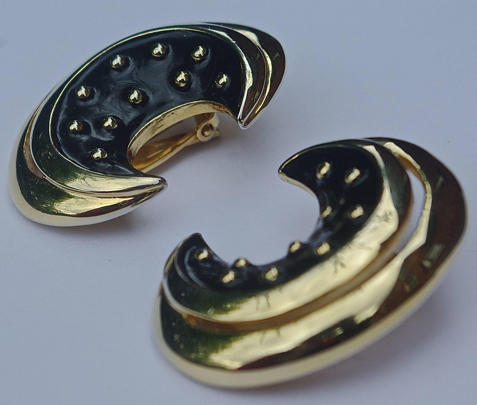 Gold plated and black enamel clip on earrings, by Courrèges Paris. Measuring 4cms / 1.57 inches, by 3cms / 1.18 inches.

The black enamel is decorated with golden balls. This is a stylish and elegant pair of vintage designer statement earrings.