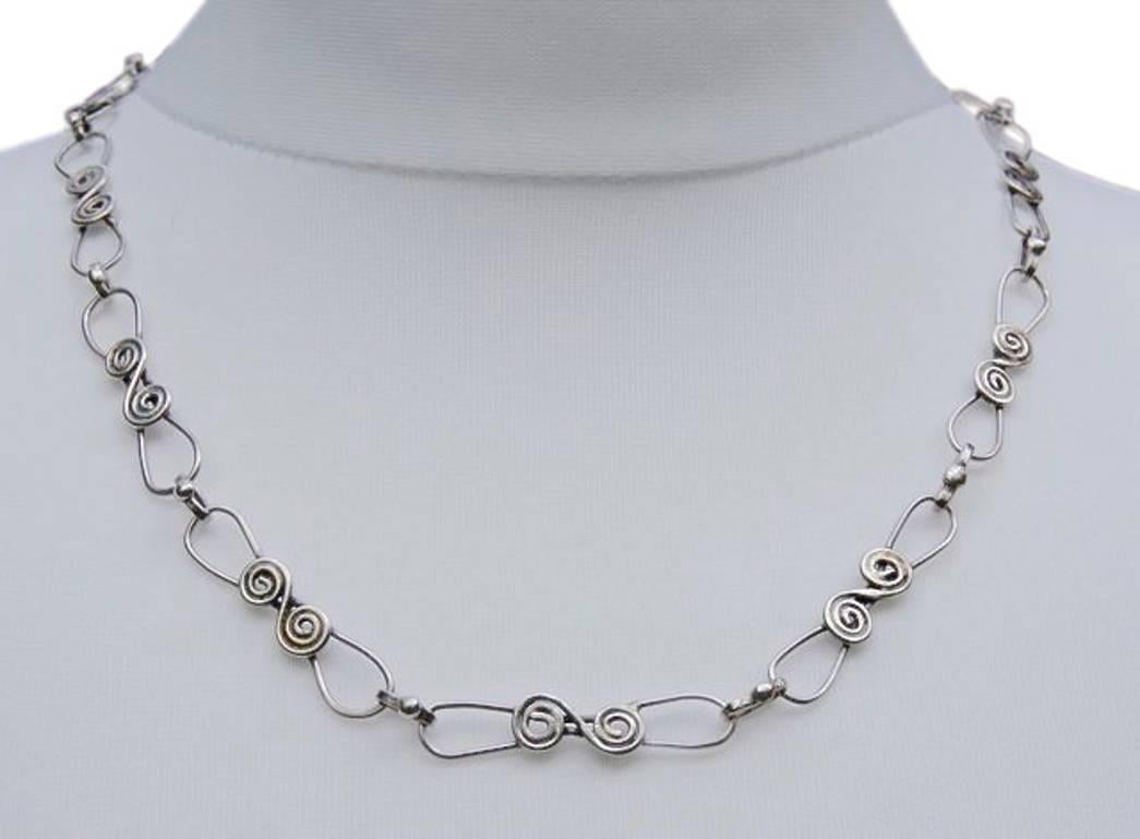 Wonderful silver swirl design link chain necklace, with a toggle clasp. There are no hallmarks, but the necklace tests as silver. Length 54cms / 21.26 inches. The workmanship of this hand forged and soldered necklace is of very high quality.

This