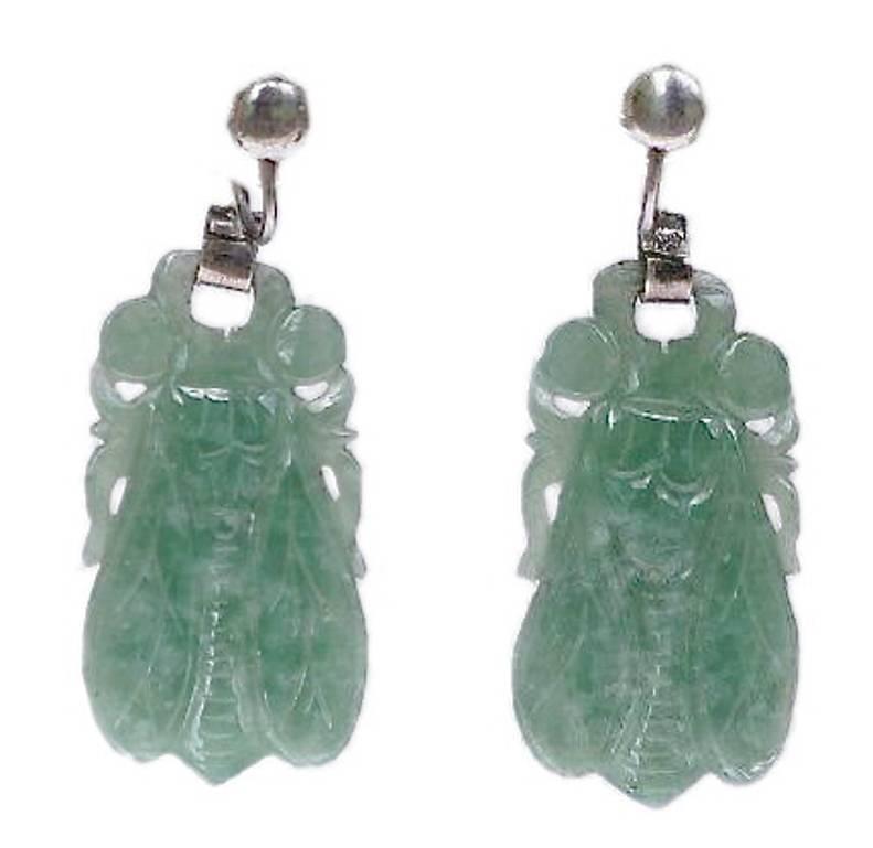 Silver and marcasite carved and polished jade drop earrings in an unusual cicada design. Length 4.4cm, 1.73 inches (including the screw back fittings) by max. 1.7cm, .67 inches.

They are unmarked, but test as silver. The jade is a wonderful mottled