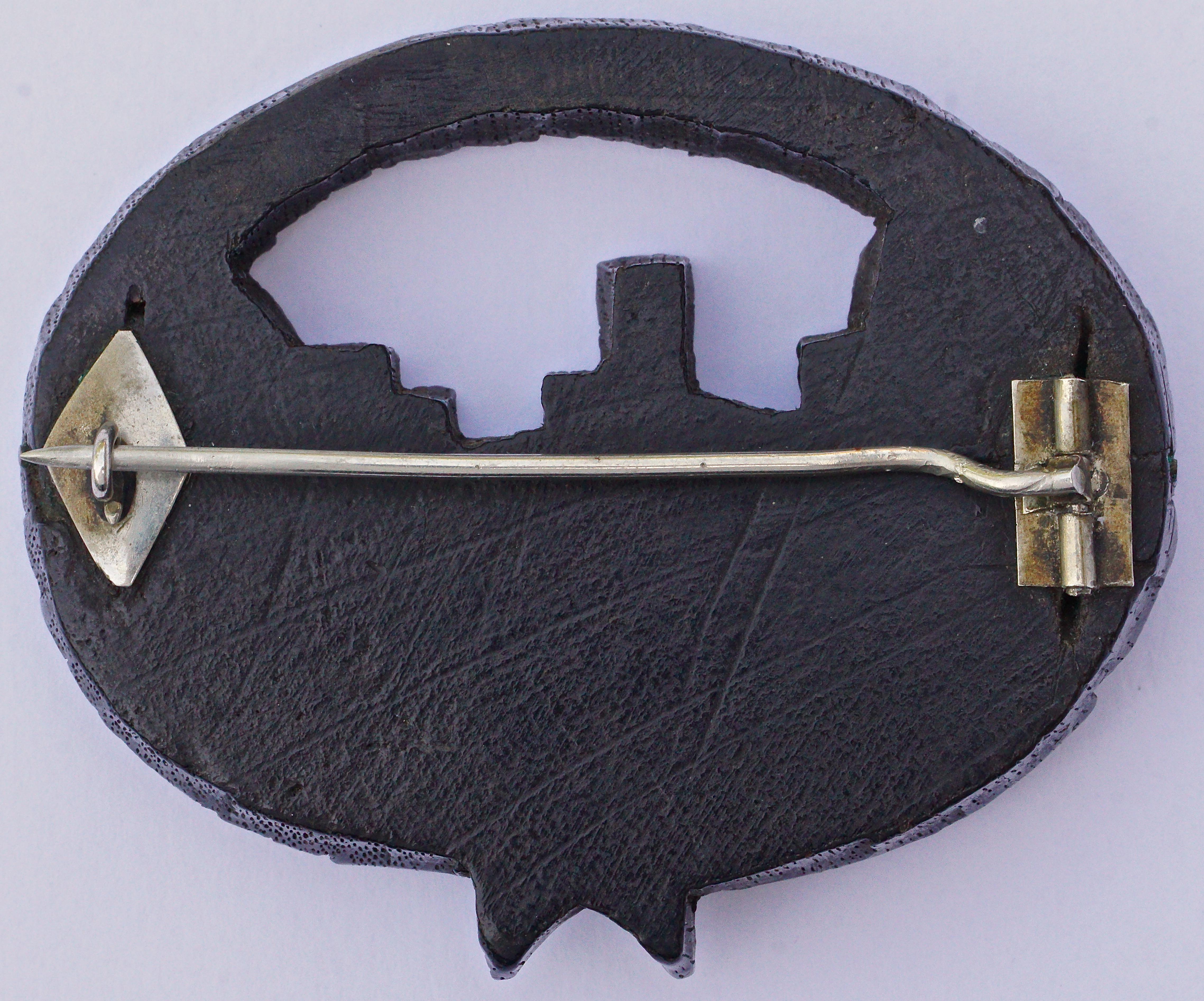 Victorian hand carved Irish bog oak brooch featuring a castle in bas relief encircled by a garland of leaves. It has the old 'C' hook clasp and tube pin assembly in silver tone metal, which dates this lovely antique brooch to around 1890. The tube