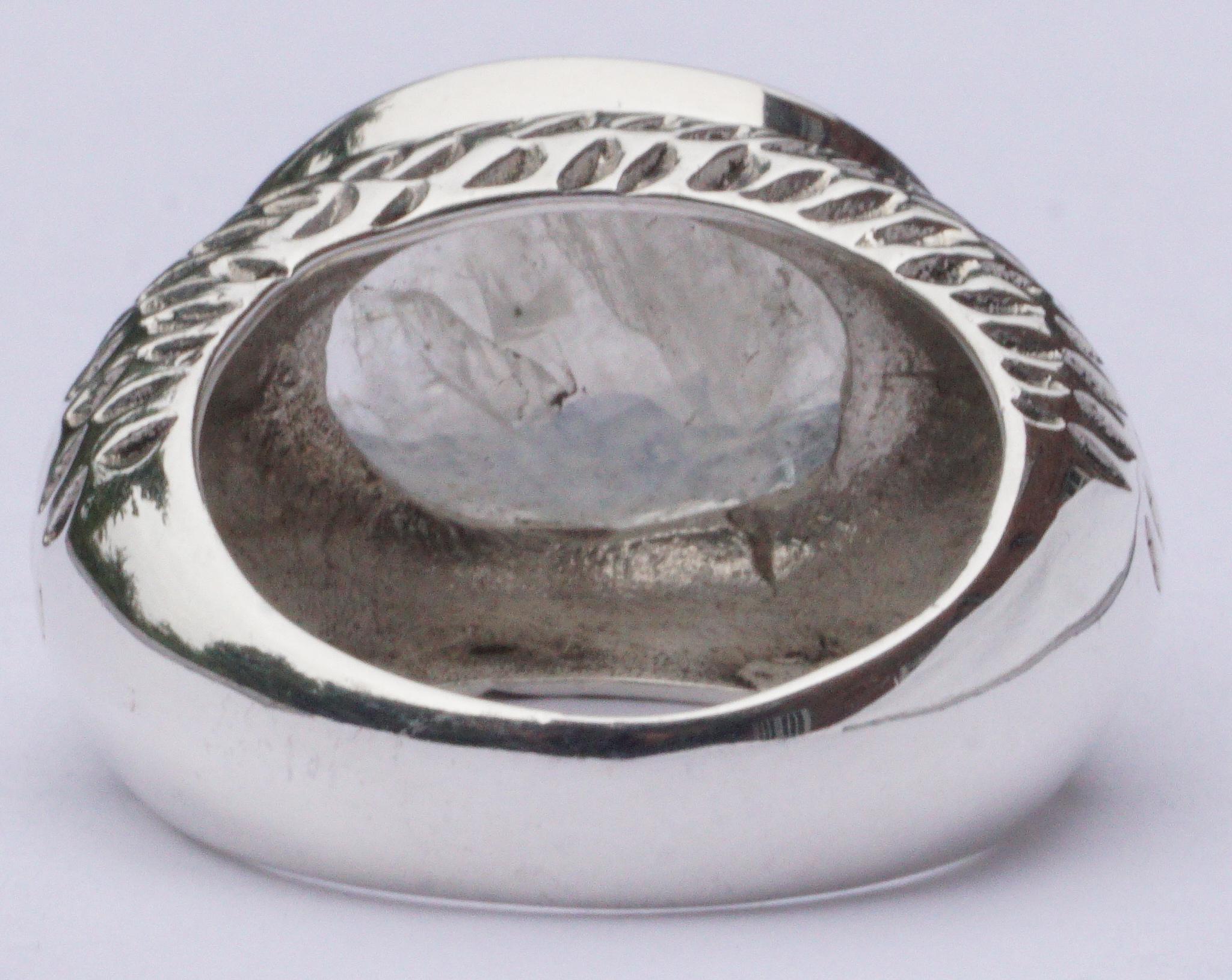 Chunky handmade silver ring with a large moonstone, stamped 925, ring size UK O / US 7. The moonstone is flat on top and faceted around the edge. It is shot through with a lovely bright blue flash of colour inside the stone. The outside of the ring
