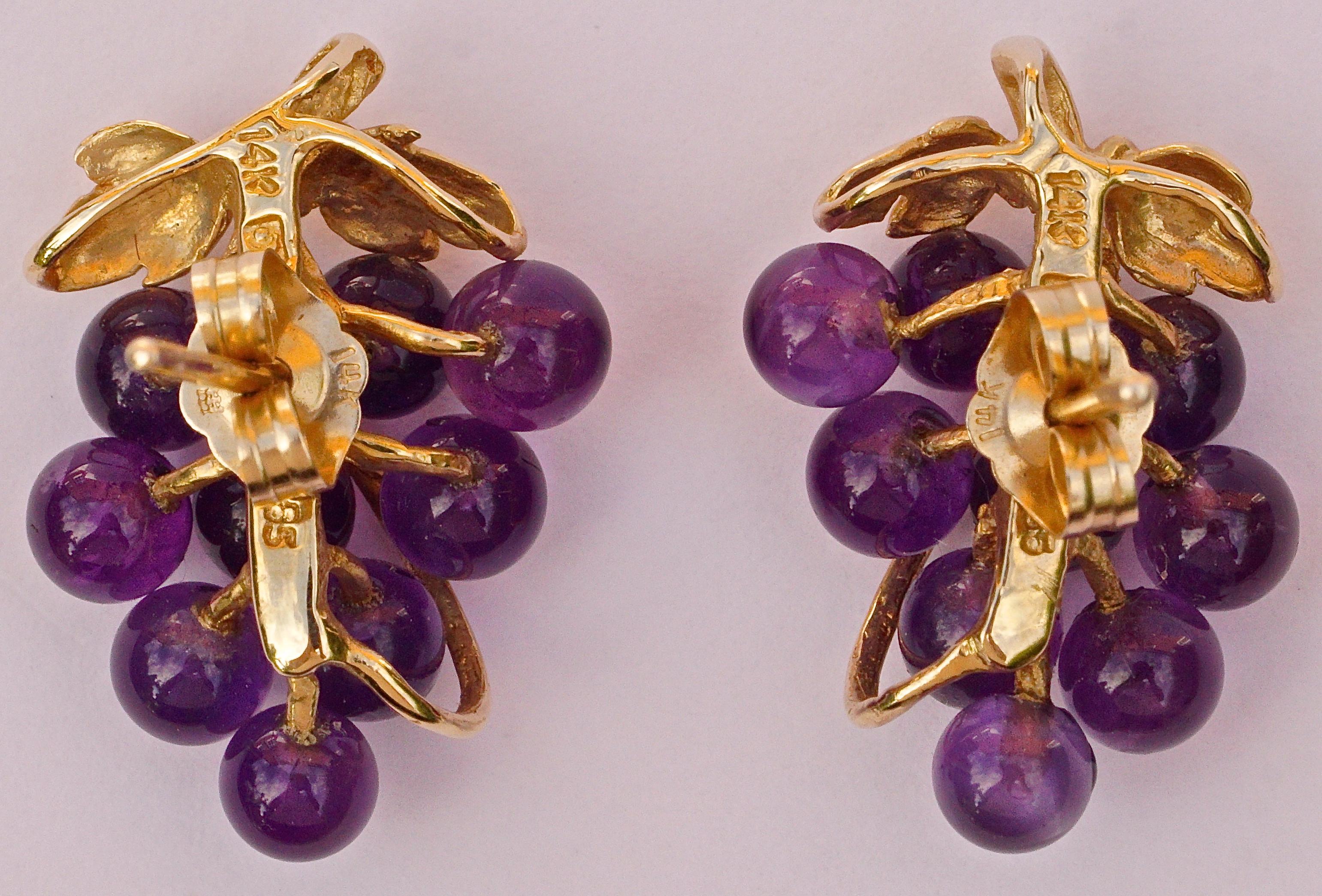 14K gold earrings for pierced ears, featuring a lovely grape design with vine leaves and nine polished amethyst grapes.  The earrings measure 1.9 cm / .75 inch by 1.2 cm / .47 inch. They are in very good condition.

These are beautiful gold and