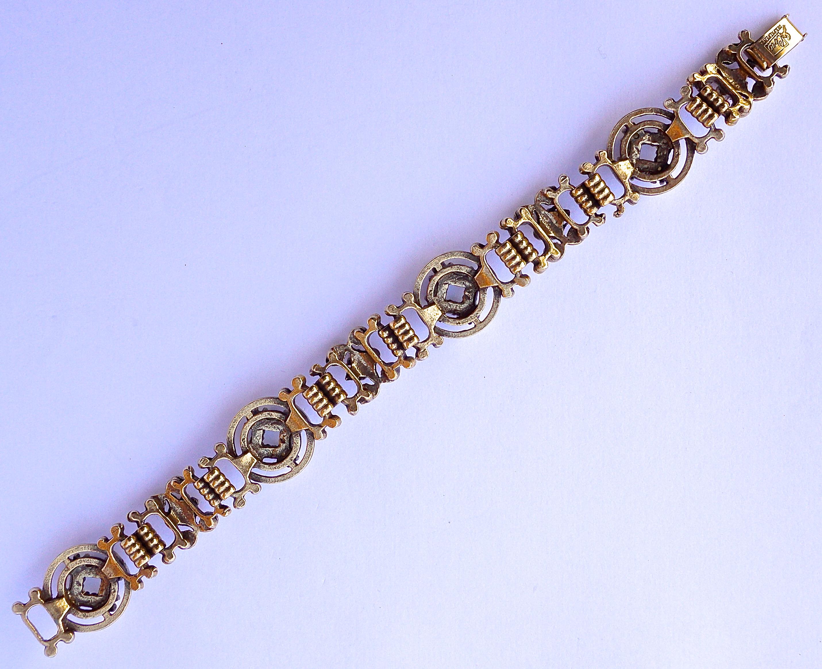 Lovely Coro Victorian Revival bracelet with an antiqued gold plated finish. Featuring alternating medallions set with clusters of faux pearls, and a swirl design with topaz rhinestones, It is signed Coro with the Pegasus mark. Measuring length 18cm,