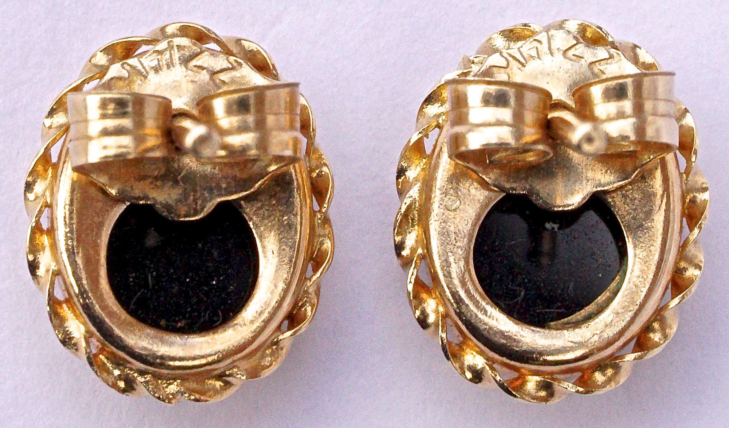 Lovely ZZ 14K gold and onyx oval stud earrings, with butterfly backs, and gold braided edging.
The earrings measure 9.5mm, .37 inch, by 7.5mm, .29 inches.

This is a great pair of classic gold and onyx stud earrings!