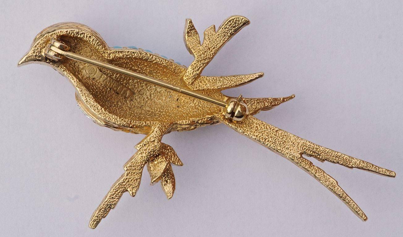 Brushed gold tone bird brooch embellished with faceted turquoise glass stones and rhinestones set in silver tone, by Panetta.

This is a wonderful quality brooch in excellent condition.

Beneditto Panetta emigrated from Naples, Italy in 1901 and