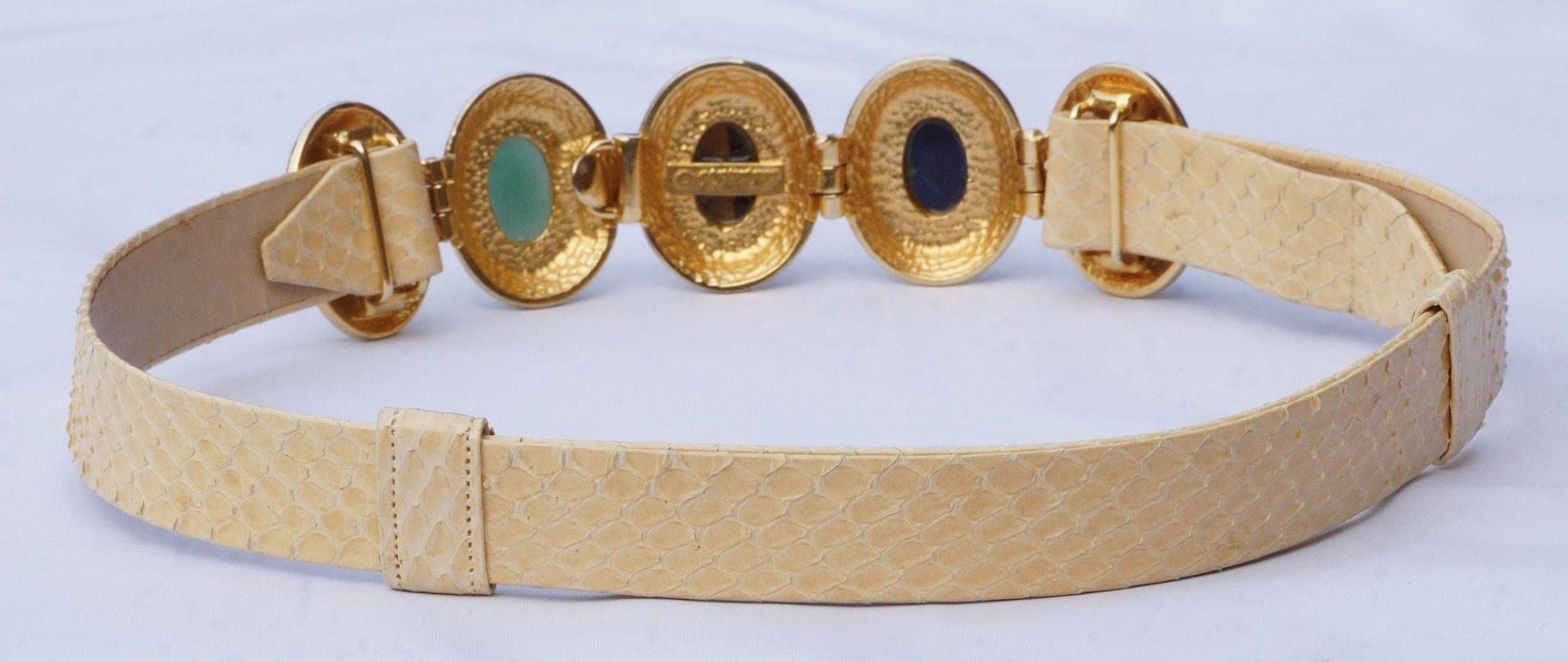 Alexis Kirk adjustable cream snakeskin belt, featuring oval semi-precious stones set in a gold tone and enamel surround.

This luxurious designer belt is very good condition.