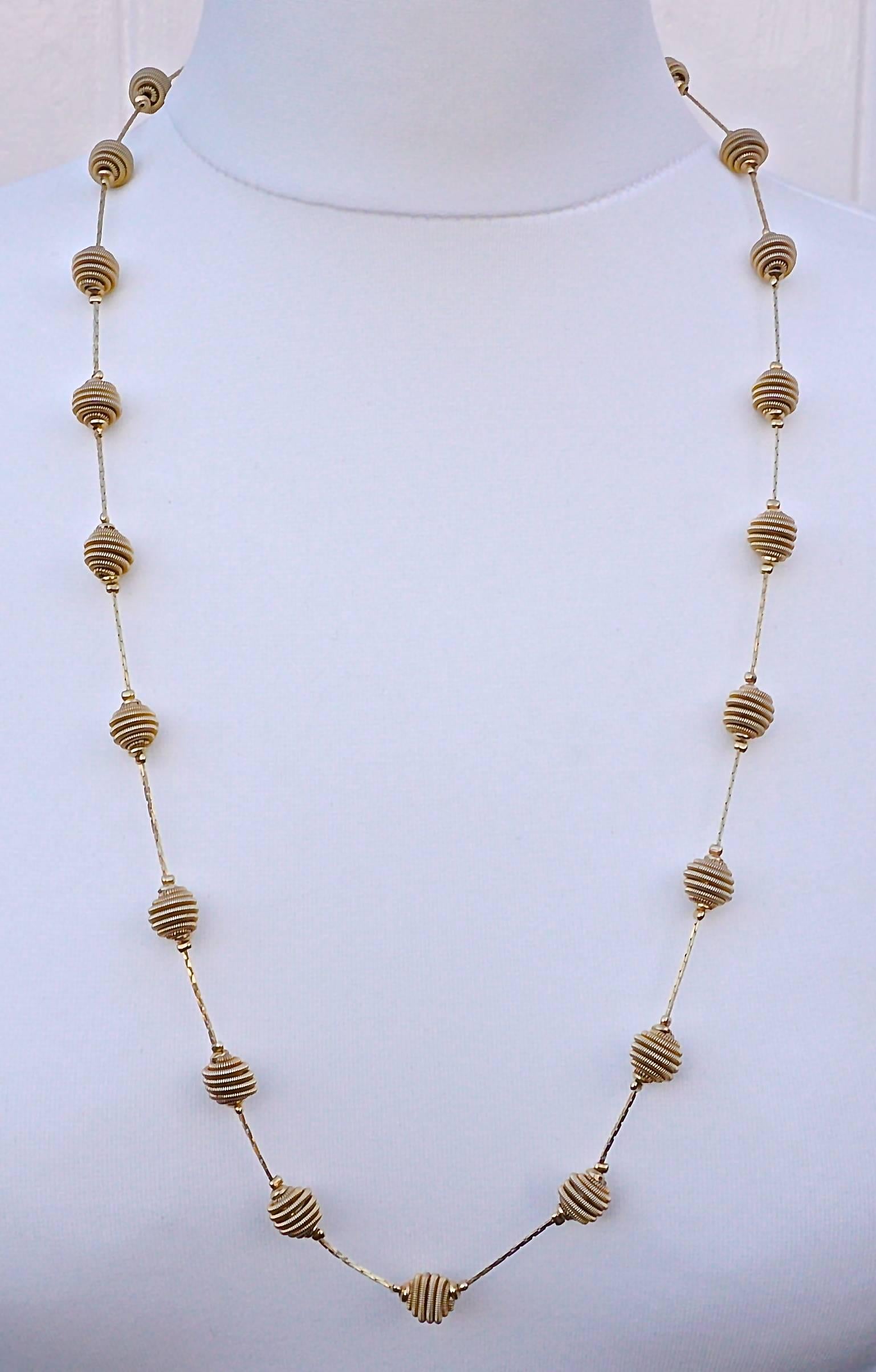 Fabulous Monet gold tone necklace with spiral balls joined together with shiny linked chain. It has the Monet hang tag. Length 76.5cm, 30 inches, and the spiral balls are diameter 1cm, .39 inch. This Monet design has been reinvented and is available