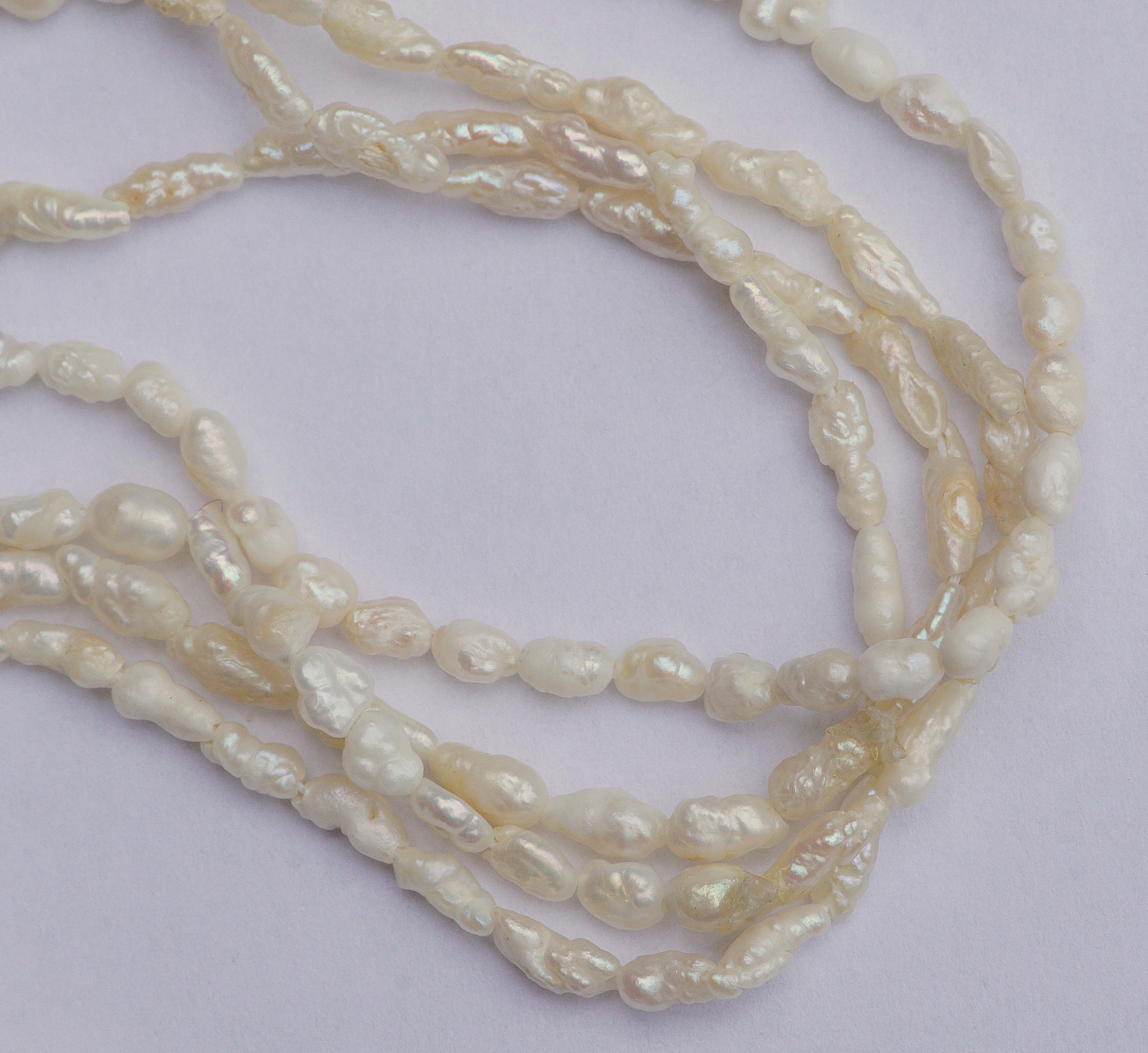 Four original strands of vintage baroque genuine rice pearls, circa 1970s. Length 91cms, 35.83 inches, they are a lovely ivory colour. The strands are not joined, and so can be worn as few or as many as you like.

Each pearl is approx. 3mm, .12 inch