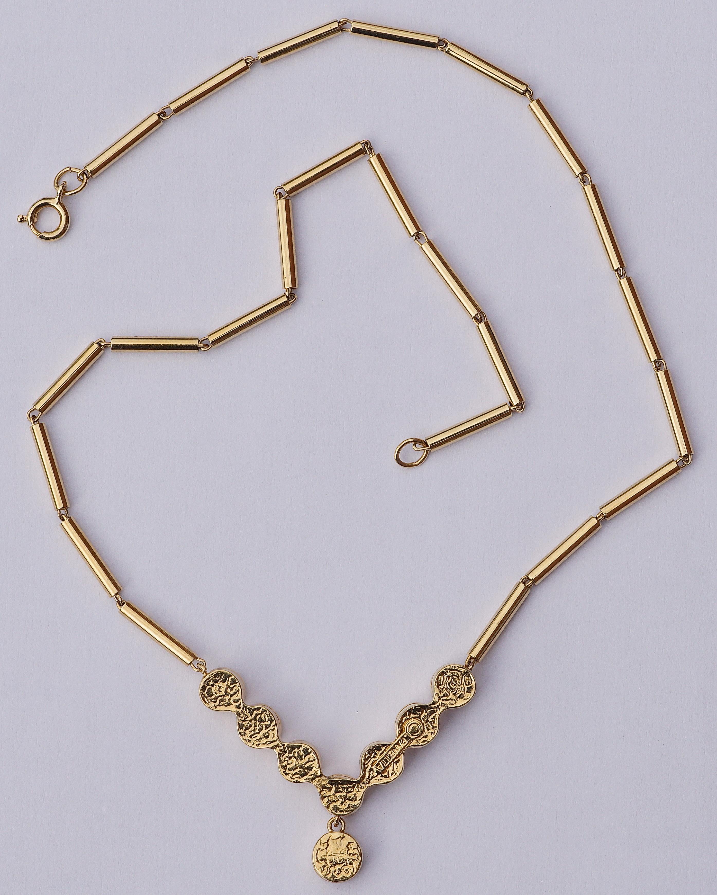 Luxurious Panetta gold tone necklace featuring seven glittering faux diamonds, and a slightly larger faux diamond drop.
The unusual chain is designed with linked golden tubes. Length 40cm / 15.75 inches, and the single drop is diameter 7mm / .27
