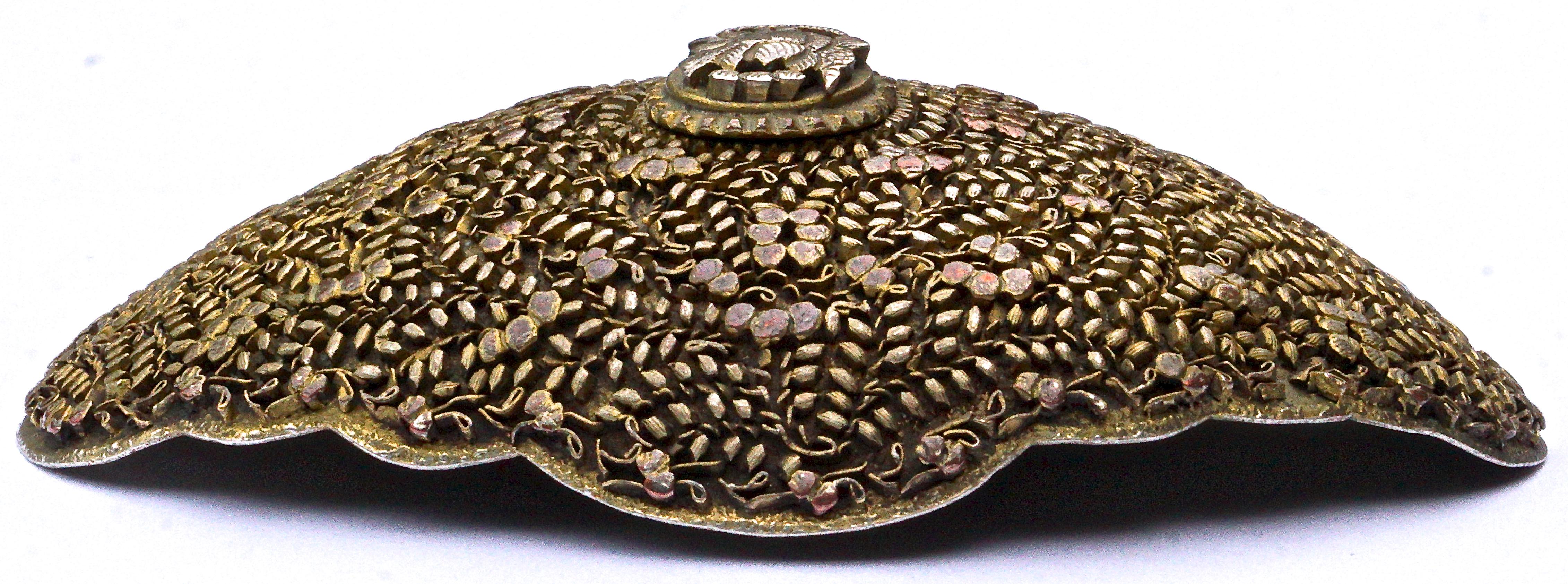 Fine antique Peranakan Chinese metal belt buckle featuring lovely intricate flower and leaf decoration. The buckle is domed with scalloped edges, and measures 10.6cm, 4.17 inches, by 7.4cm, 2.9 inches. The centre is a little loose, but secure. We