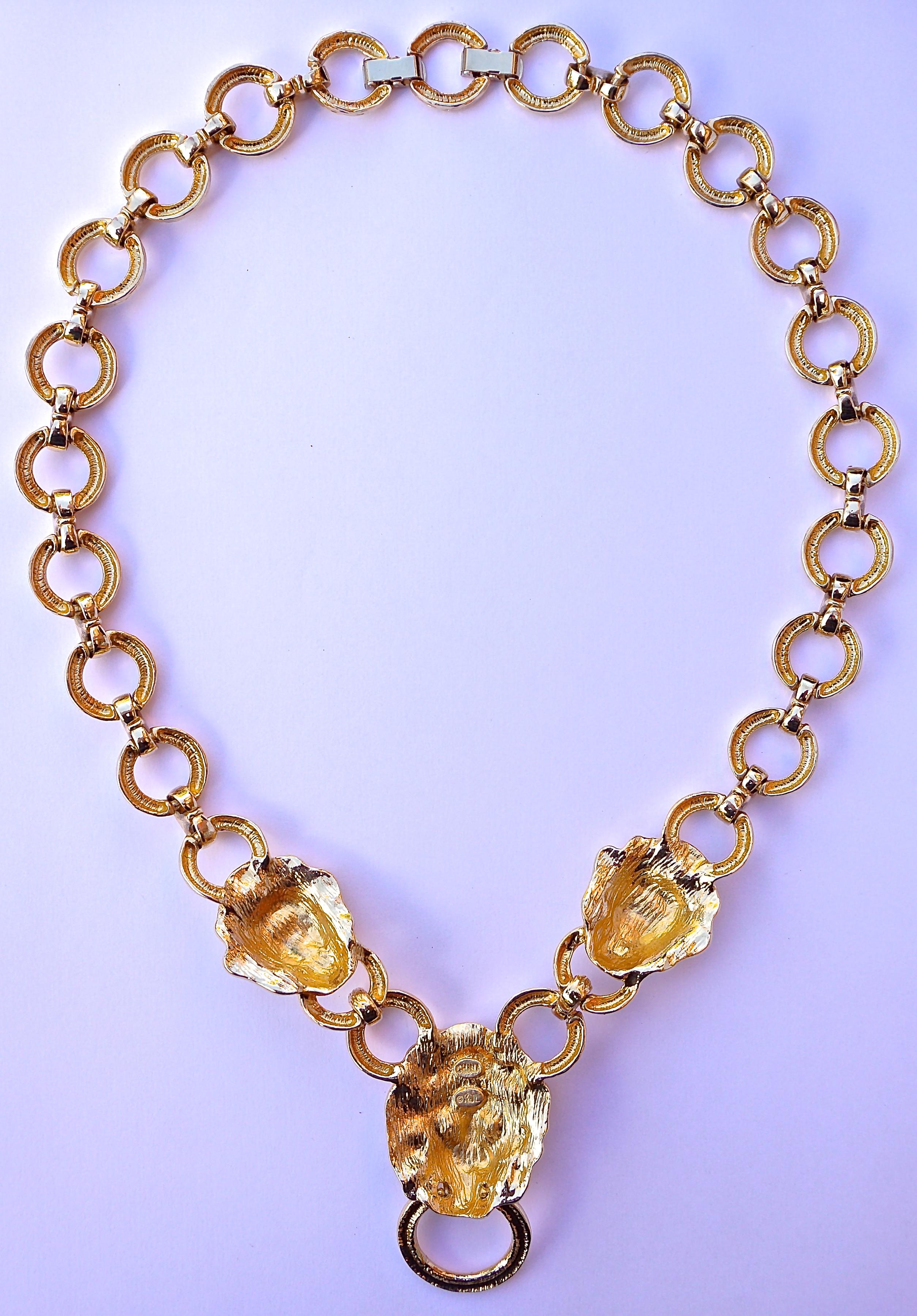 Fabulous Kenneth Jay Lane 1990s gold plated necklace, featuring three doorknocker lions heads, and textured link chain. It is stamped KJL© China, and has a removable clasp closure to adjust the length. The necklace measures length approximately