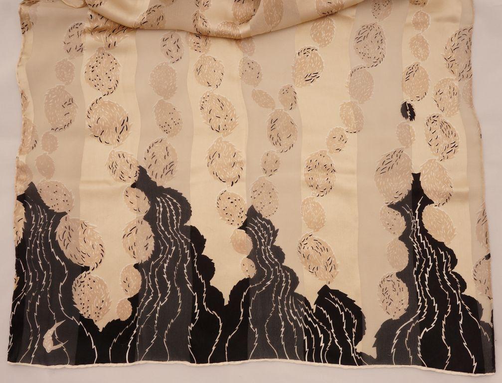 Fabulous long silk scarf by Georgina von Etzdorf, featuring a stylized leaf design in black and beige, and alternating panels of chiffon silk. It has hand rolled edges, and was made in England. Measuring length 170cm, 66.93 inches, by width 56cm,