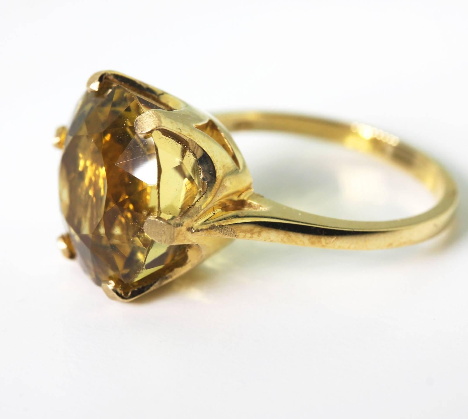 Set in 14 Kt yellow gold ring this beautiful glittering 9 carat yellow Citrine flashes glints of gold in the light.  The ring is a size 7 (sizable).