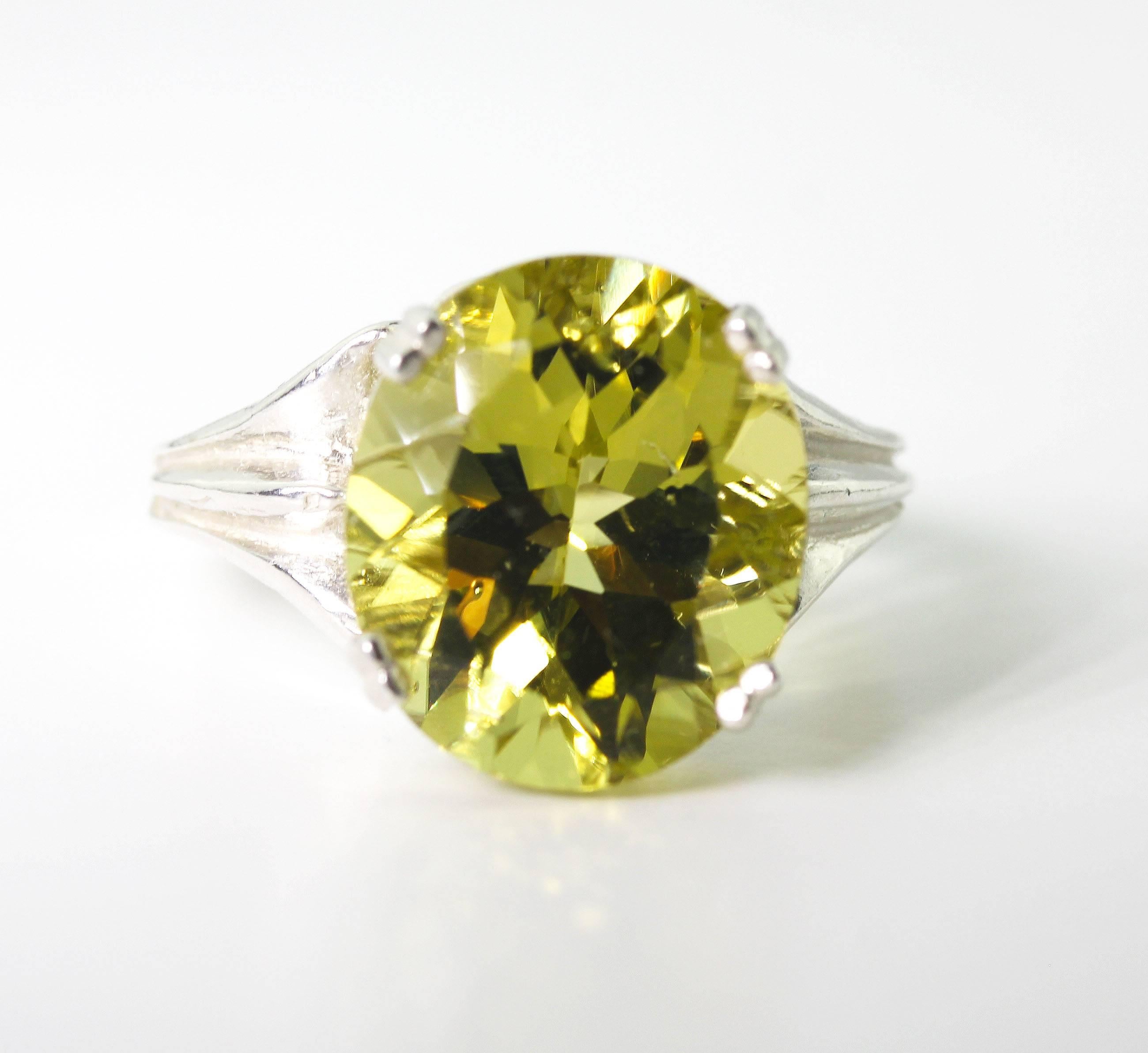 Glittering 10 carat yellow oval deep Lemon Quartz (12.2 mm x 14mm) set in a lovely Sterling Silver ring size 7 (sizaable)    More from this seller by putting gemjunky into 1stdibs search bar.