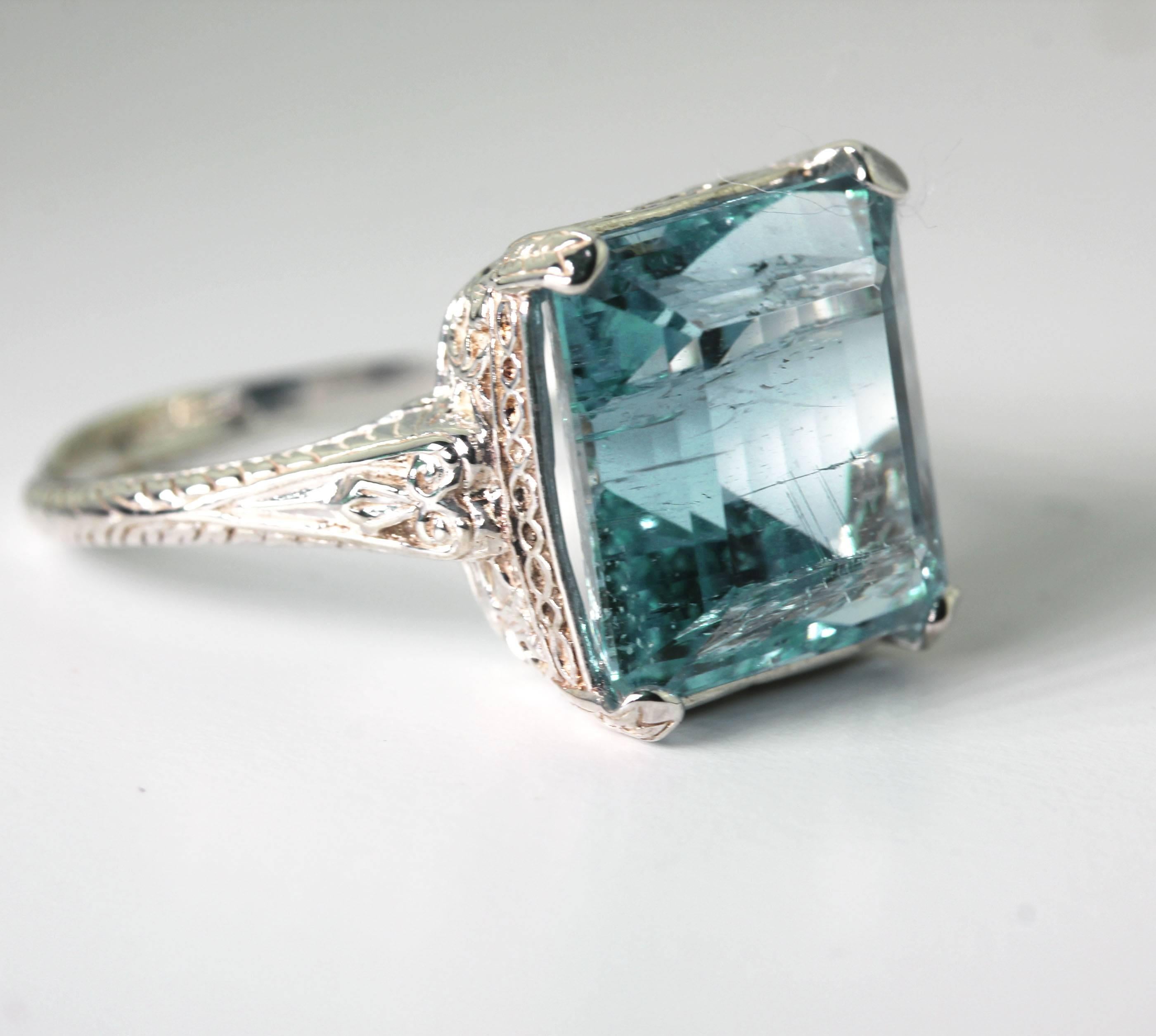 Beautiful glittering intense blue Santa Maria Brazilian 8 carat Aquamarine set in a sterling silver ring size 9 (sizable).  Note the inclusions increase the sparkle of the gemstone which measures 13 mm x 12.2 mm).