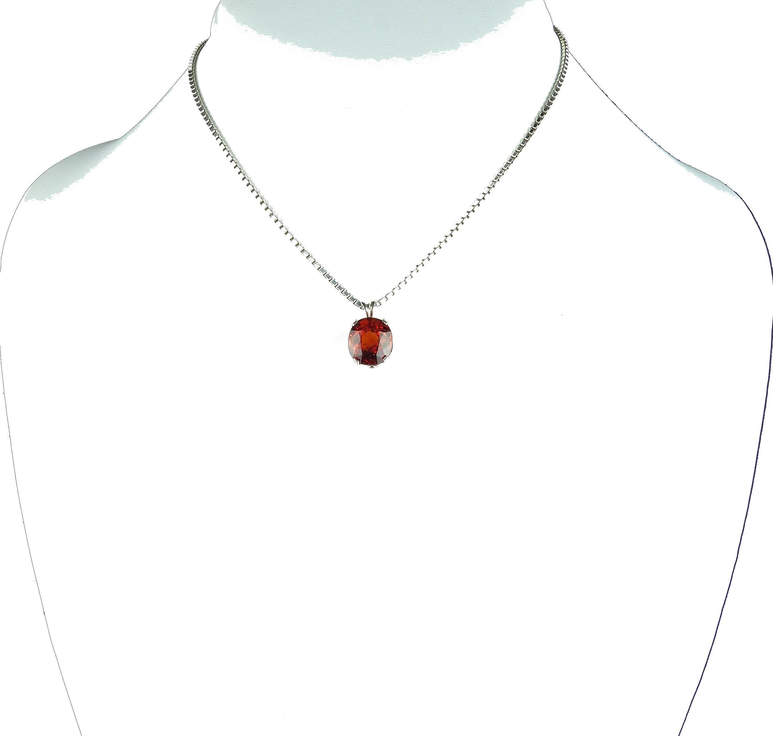 This 6 carat brilliant natural Spessartite Garnet measures 10.7 mm x 9.6 mm and is set in a Sterling Silver pendant.