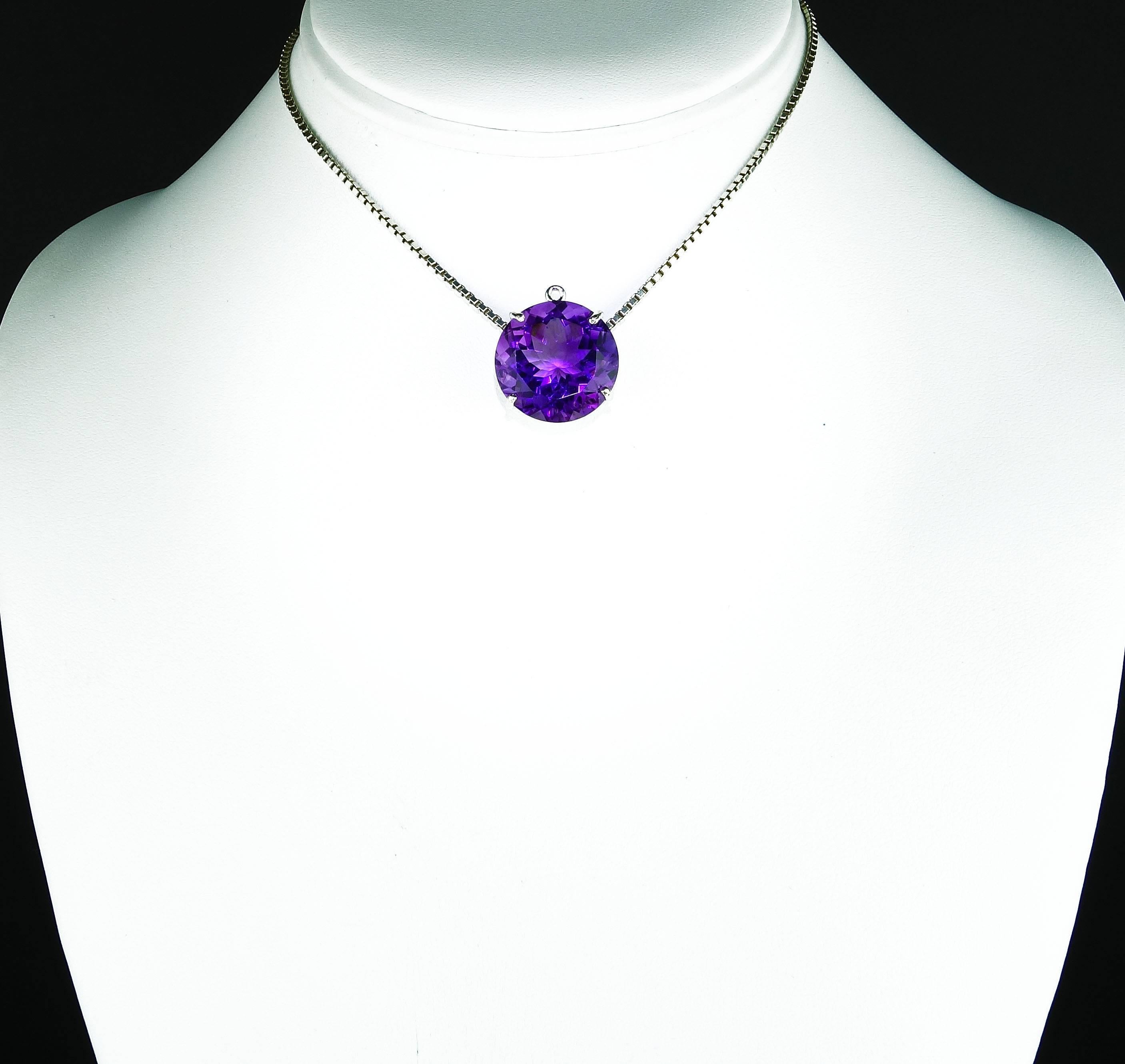 Brilliant 19.76 carat purple Amethyst with all the natural glittering pink flashes is 18 mm and is set in a Sterling Silver pendant.