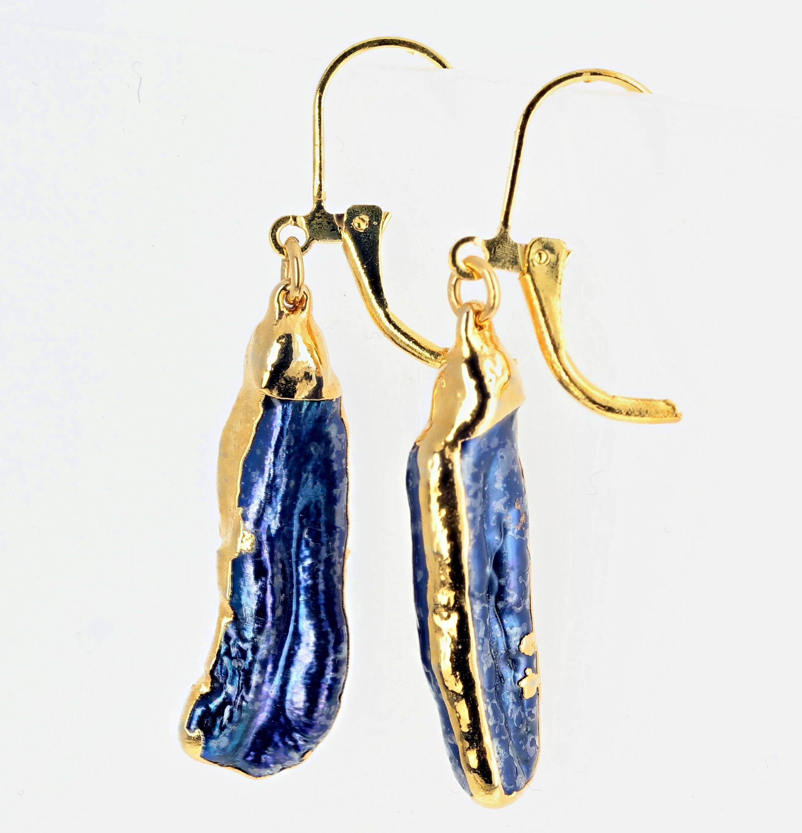 Glowing blue/purple/pinky dangling Abalone swinging from gold plated lever back earrings. They hang approximately 1.76 inches long from top of lever to bottom of Abalone.  They each hang best in one direction.  