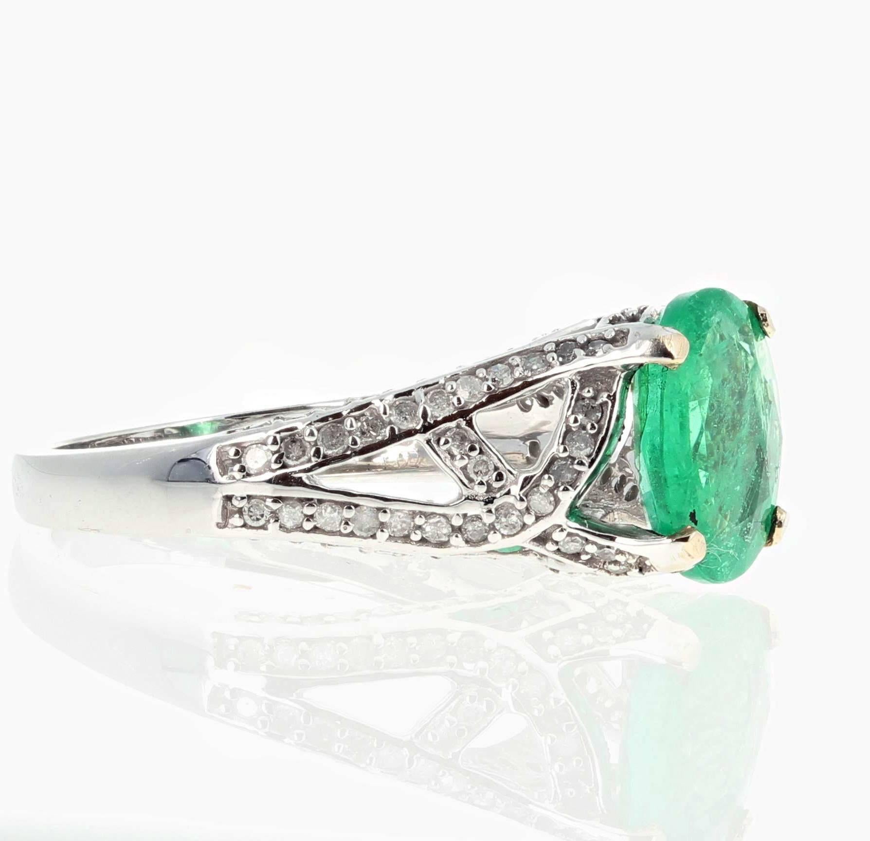 Bright beautiful 3 carat Colombian Emerald accented with 0.5 carats of white sparkly Diamonds set in a 10Kt white gold ring size 7 (sizable FOR FREE).  Note that the ring is designed to hold the Emerald slightly at an angle.   
