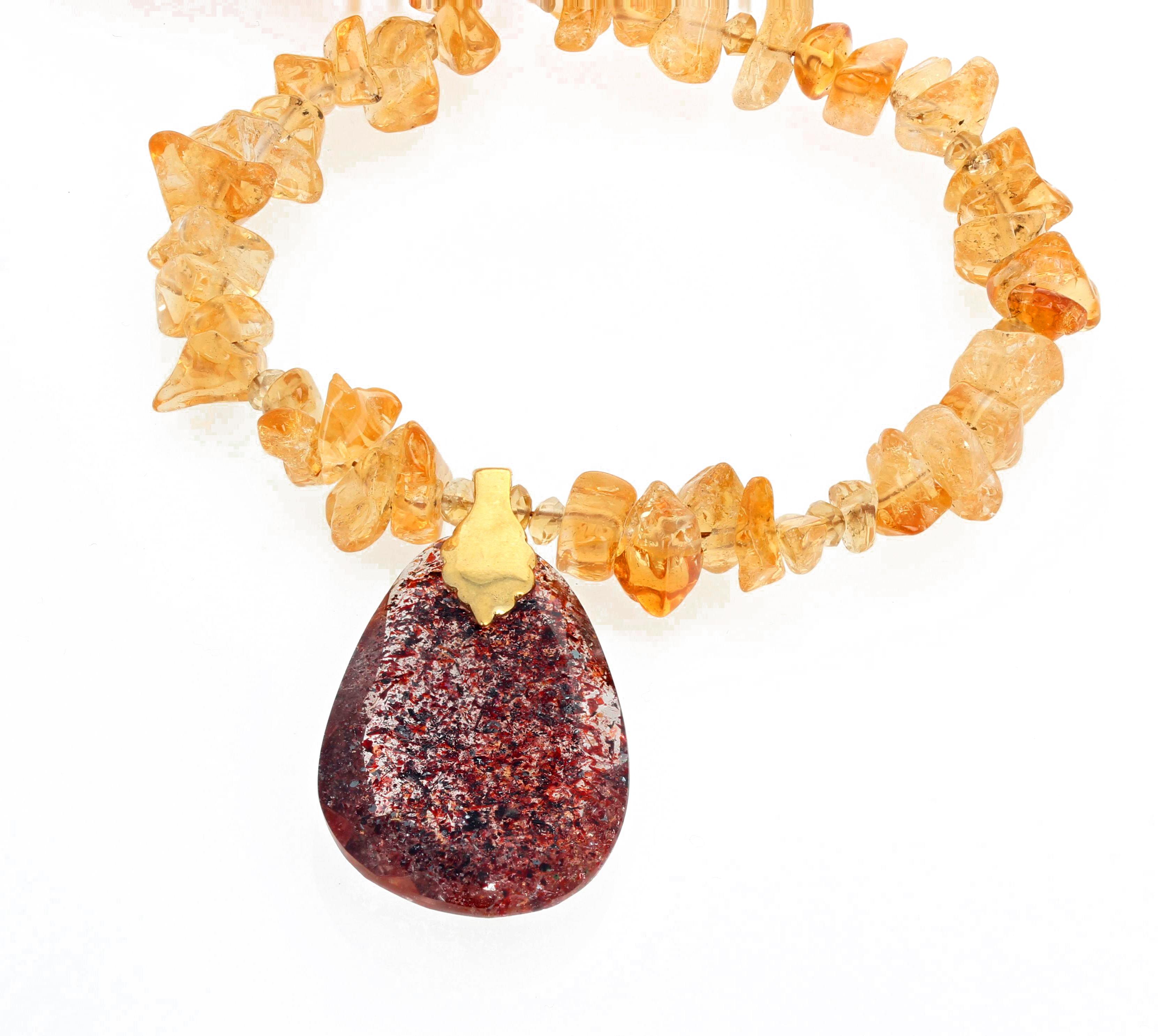 Unique glittering translucent strawberry/goldish Titanium pendant hangs from this lovely 19 inch necklace of chipped polished chunks of golden Citrines.   The Titanium measures 1 1/2 inches long.  