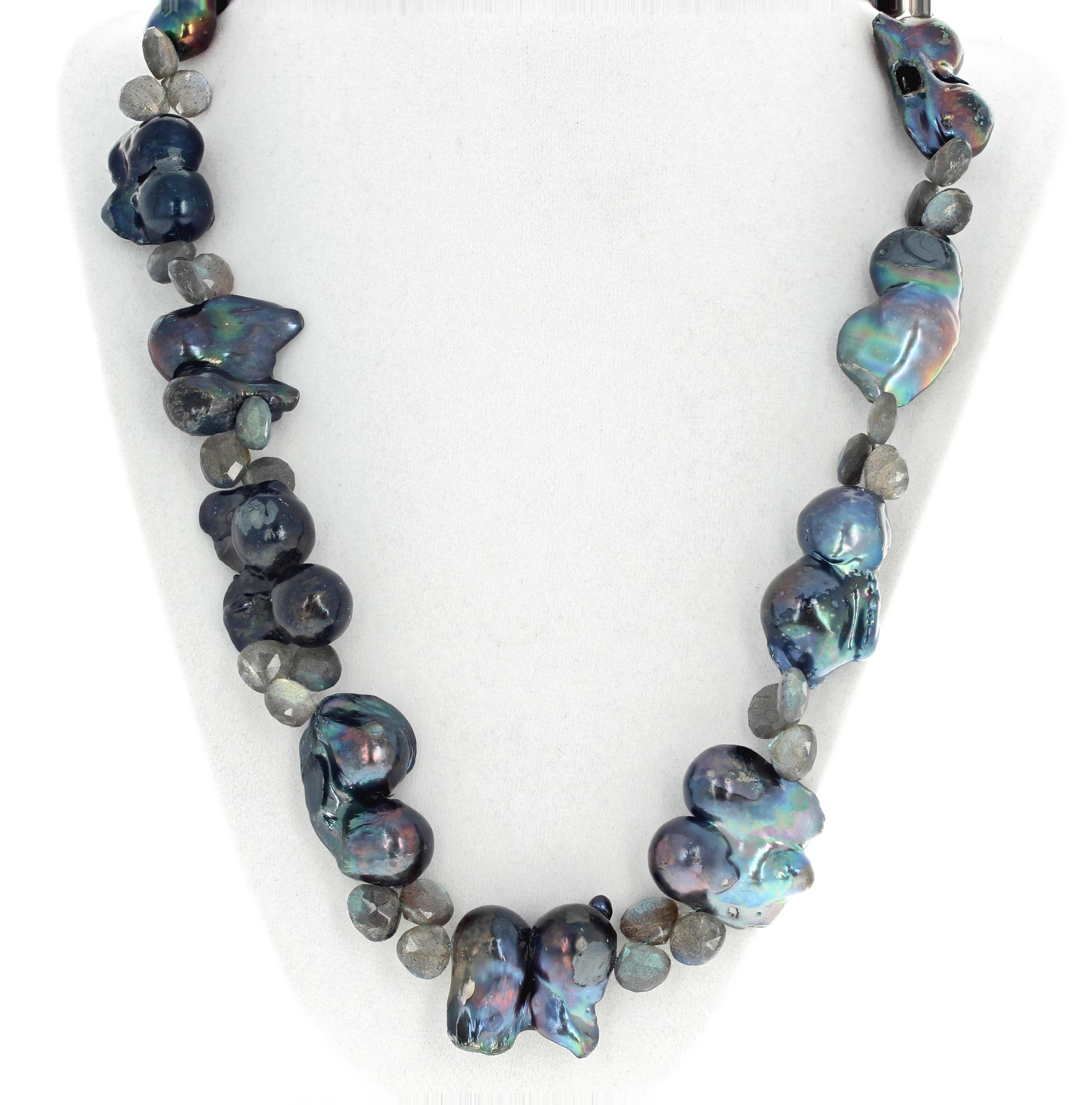  Splendid Unique cultured freshwater Peacock Pearls enhanced with glittering gem cut leaves of natural Labradorite set in a handmade necklace with a sterling silver clasp.  The necklace is 
23 inches long.  More from this seller by putting gemjunky