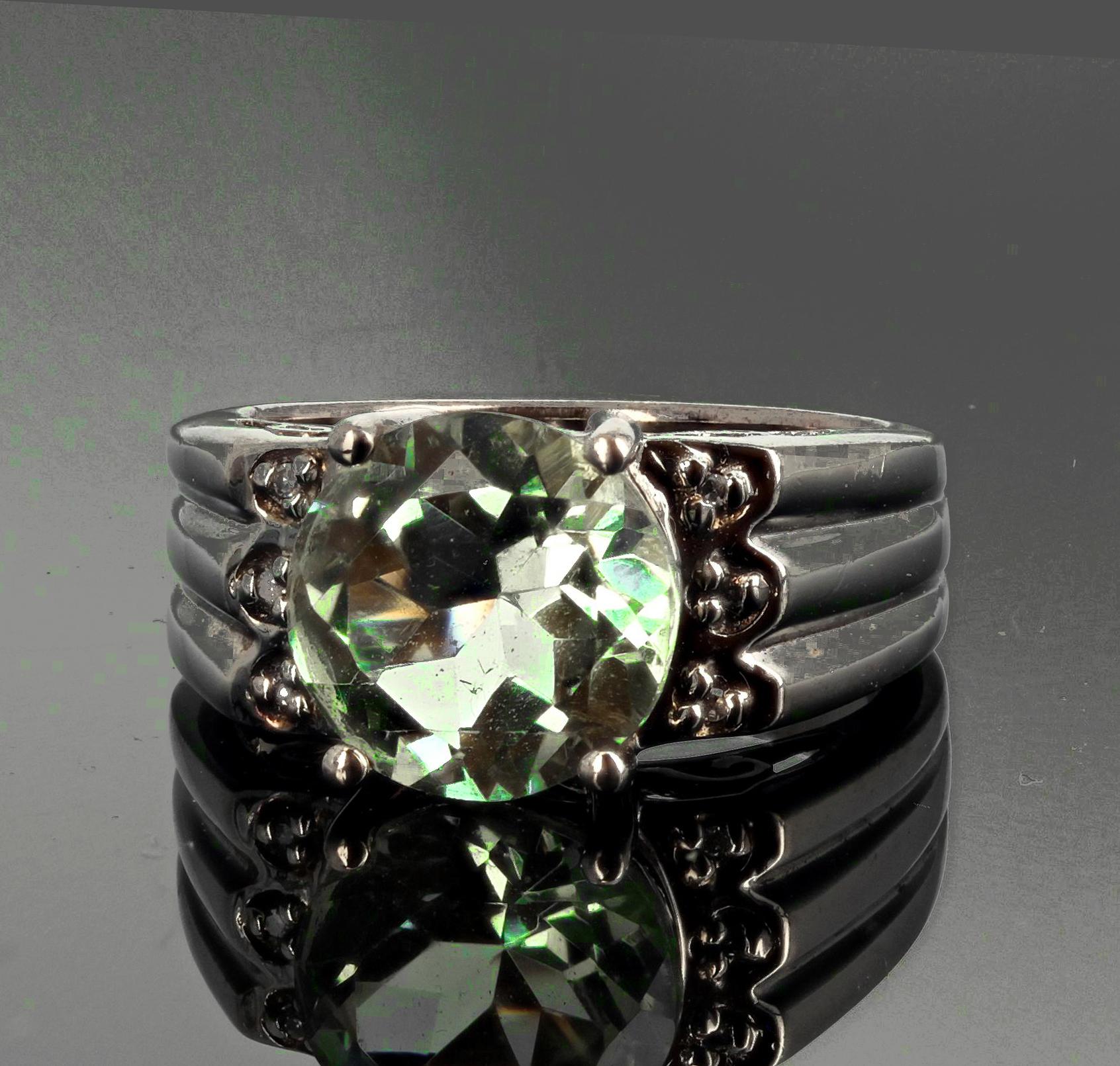 Unique round 10mm glittering green clear 3 carat natural Praziolite ( also known as a green Amethyst ) with tiny sparkling side stone set in a lovely sterling silver ring size 6 (sizable for free).   
