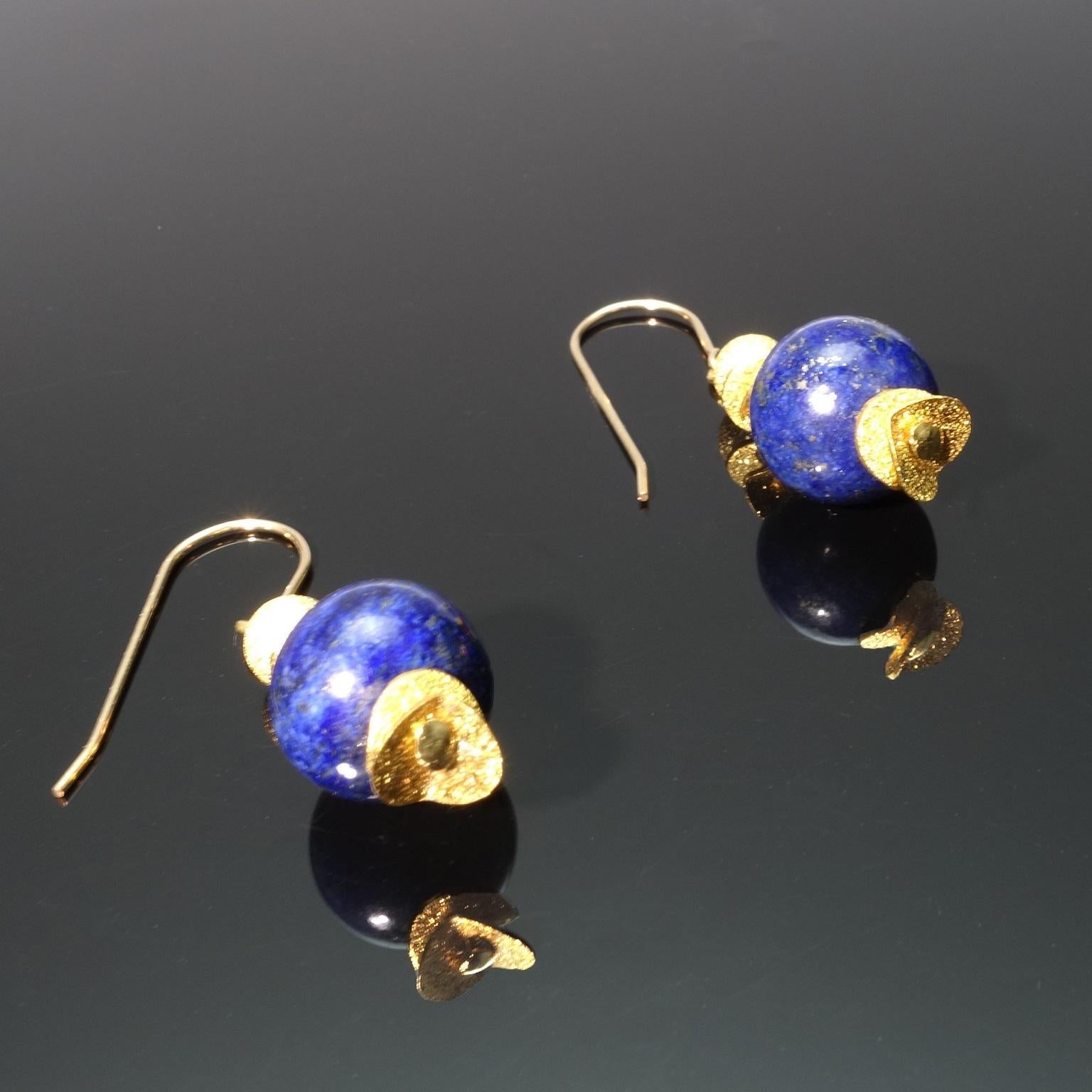 Custom made highly polished Lapis Lazuli spheres with gold tone accents earrings.  These unique earrings are 1.5 inches from the top of the gold plated french hook to the bottom of the gold tone flutter accent. The lovely lapis are 12mm in diameter.