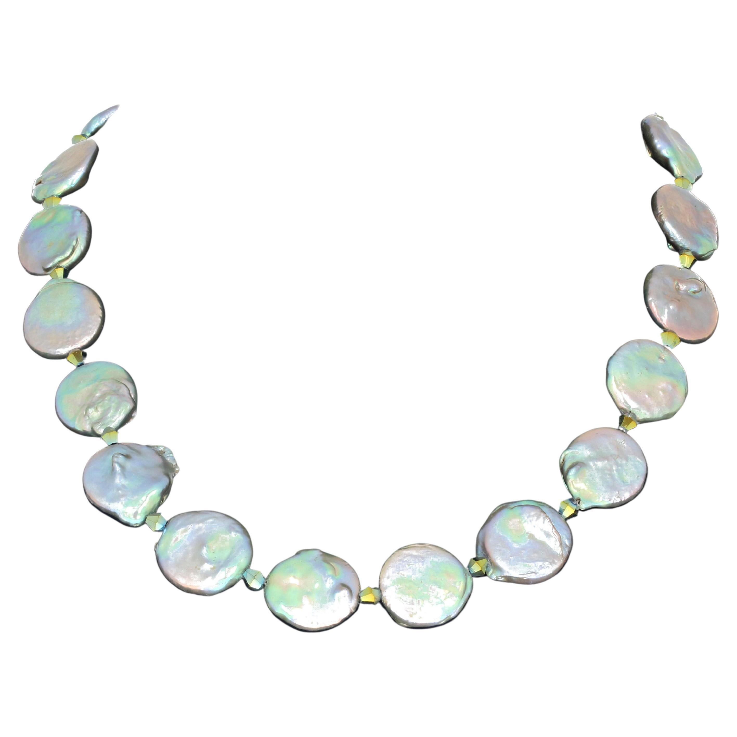 This glowing 17.25 inch long Coin Pearl necklace set with a silver tone clasp is enhanced with little Czech crystal sparkles.  Depending on what light you are in the pearls glow many colors of silver or blue or green  or pinkish reflections.  The