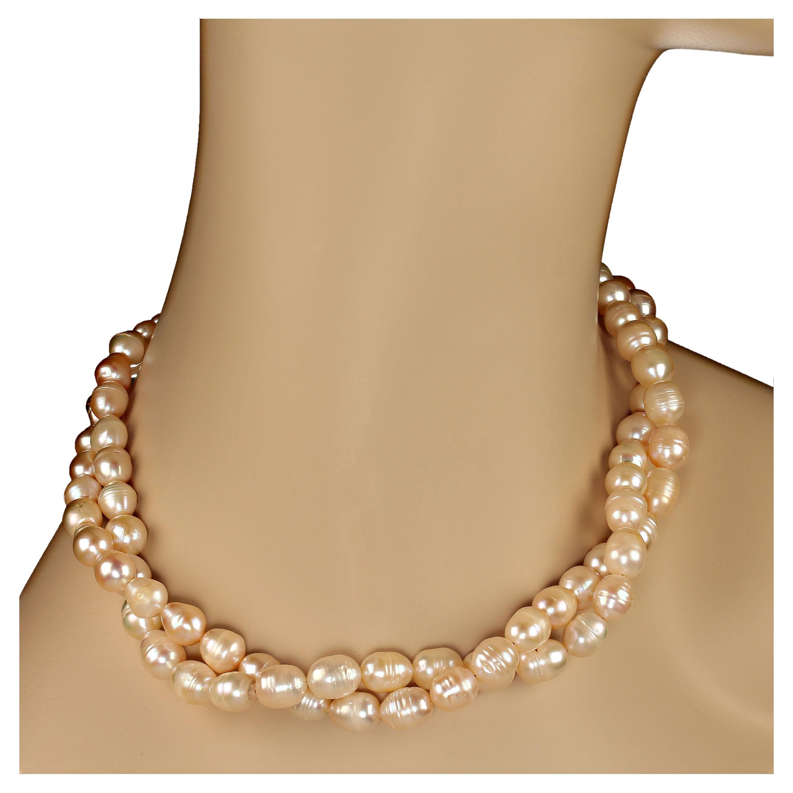 21 Inch traditional 2 strand pearl necklace. These soft pink pearls are complementary to all skin tones. The pearls range from approximately 6mm to 11mm and are oval (potato) shaped.  The necklace can be worn with two strands side by side or gently