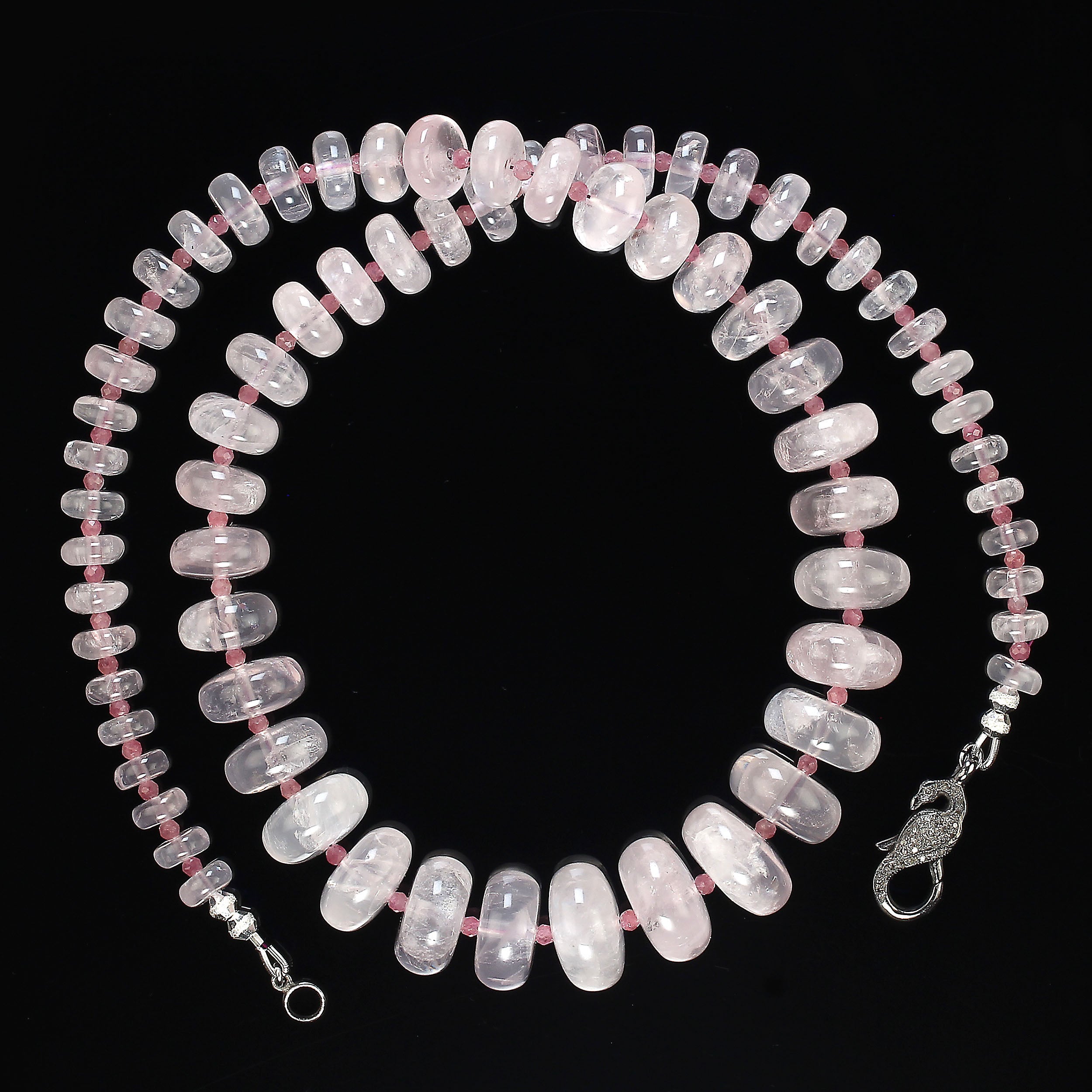 Happy Valentine's Day Gift!
Gorgeous transparent smooth rondelles of rose quartz in this 24-inch necklace.  The rose quartz is accented with faceted darker 3mm pink tourmaline. These rose quartz graduate 8 to 18 mm.  This elegant necklace is secured
