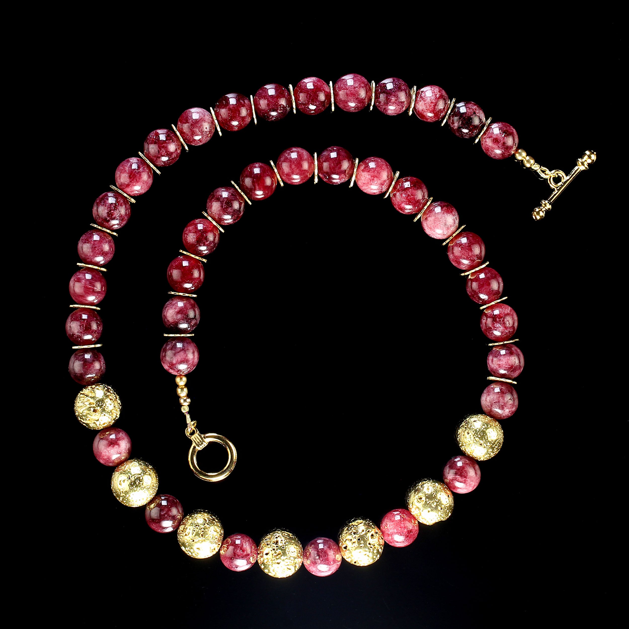 Elegant and unique garnet necklace of smooth highly polished 10 MM round translucent garnets.  These lovely gemstones are accented with gold tone 12 MM lava rocks across the front of the necklace and daisy shaped accents between the remainer of the
