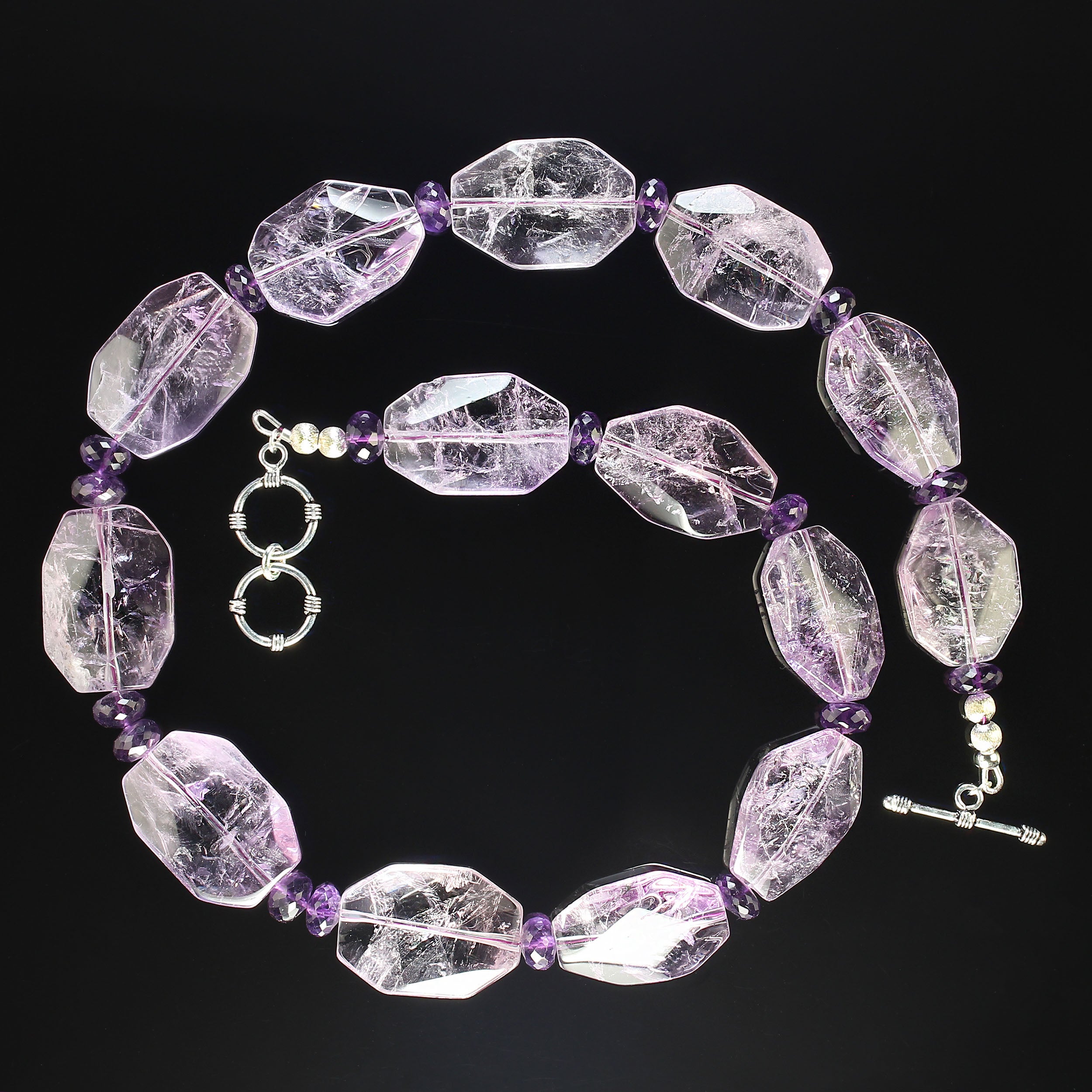Fascinating and unique necklace of Rose of France Amethyst octagon shaped in highly polished tablets. These gorgeous tablets are accented with darker amethyst faceted rondelles. This one-of-a-kind necklace is secured with a two ring toggle clasp.