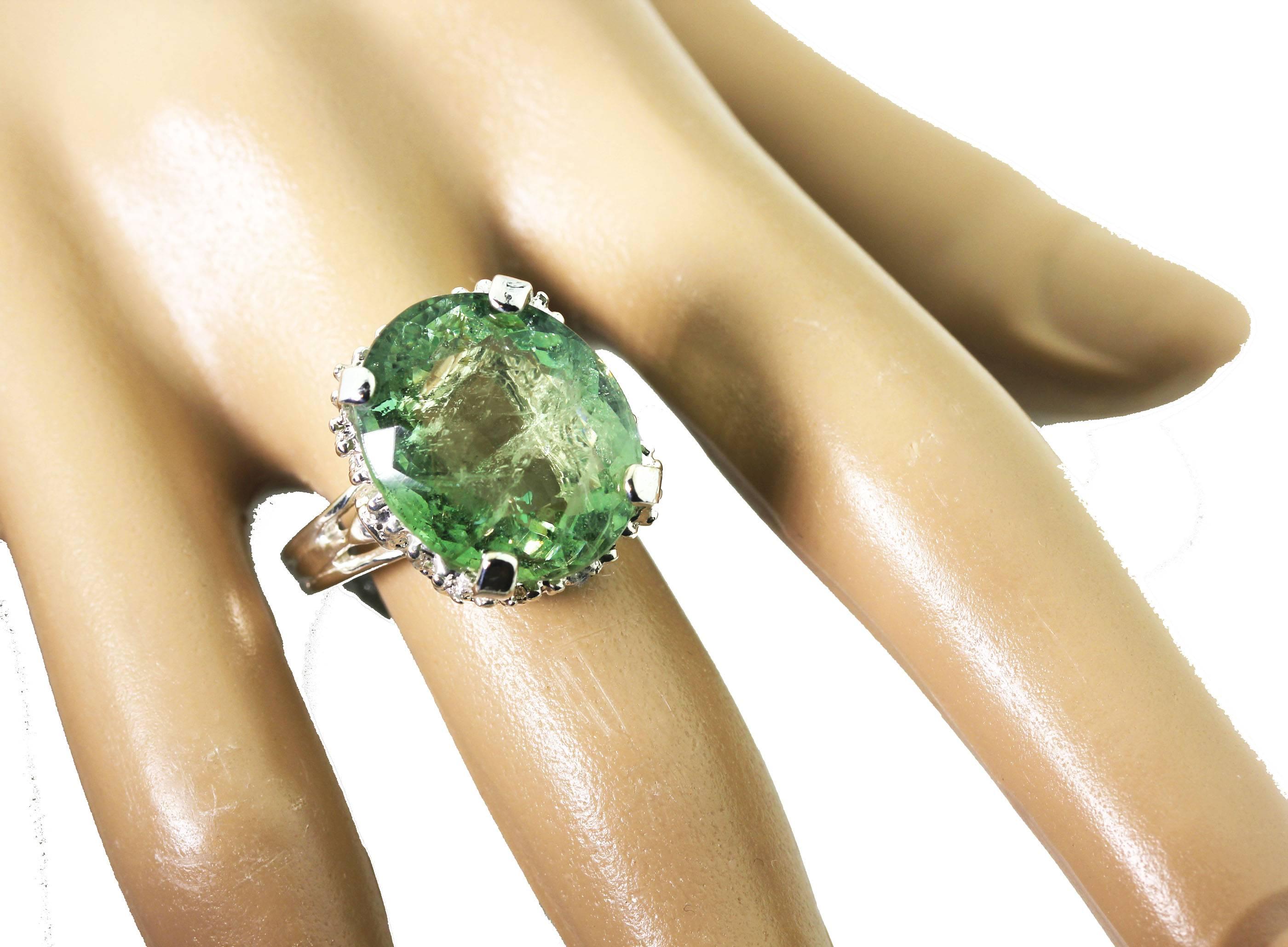 Brilliant Rare 14.98 carat greenish yellowish sparkling Tourmaline (17.2 mm x  14.4 mm) is set in a sterling silver ring size 8.5 (sizable for free). The many teeny tiny natural inclusions make it sparkle more !  This is really gorgeous on you