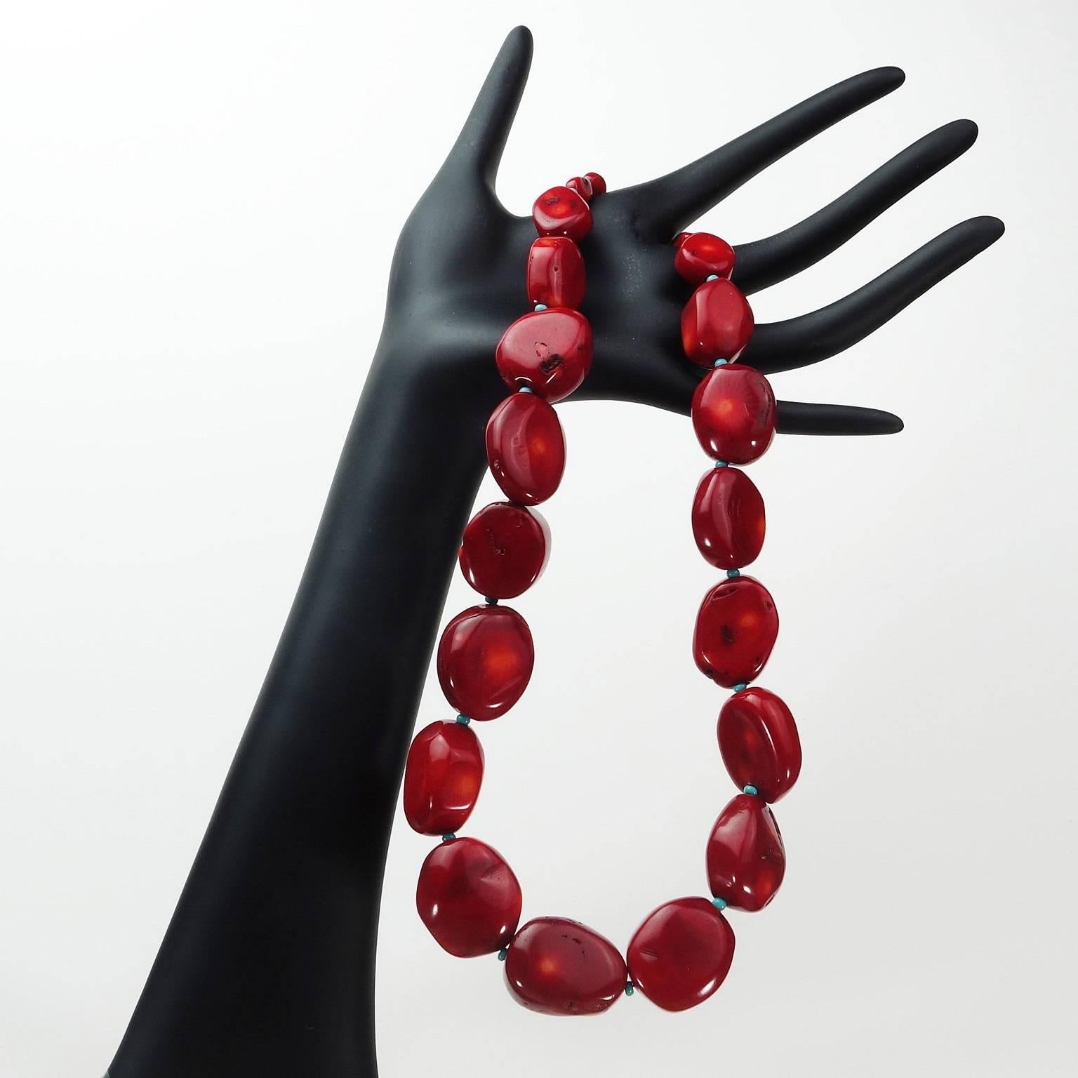 Graduated Bamboo Coral Necklace (19inches) in that lovely deep mottled wine red, spaced with tiny turquoise glass beads. This shade of red enhances whatever you're wearing. The 19 inches is secured with a gold tone S clasp. Great winter color, right